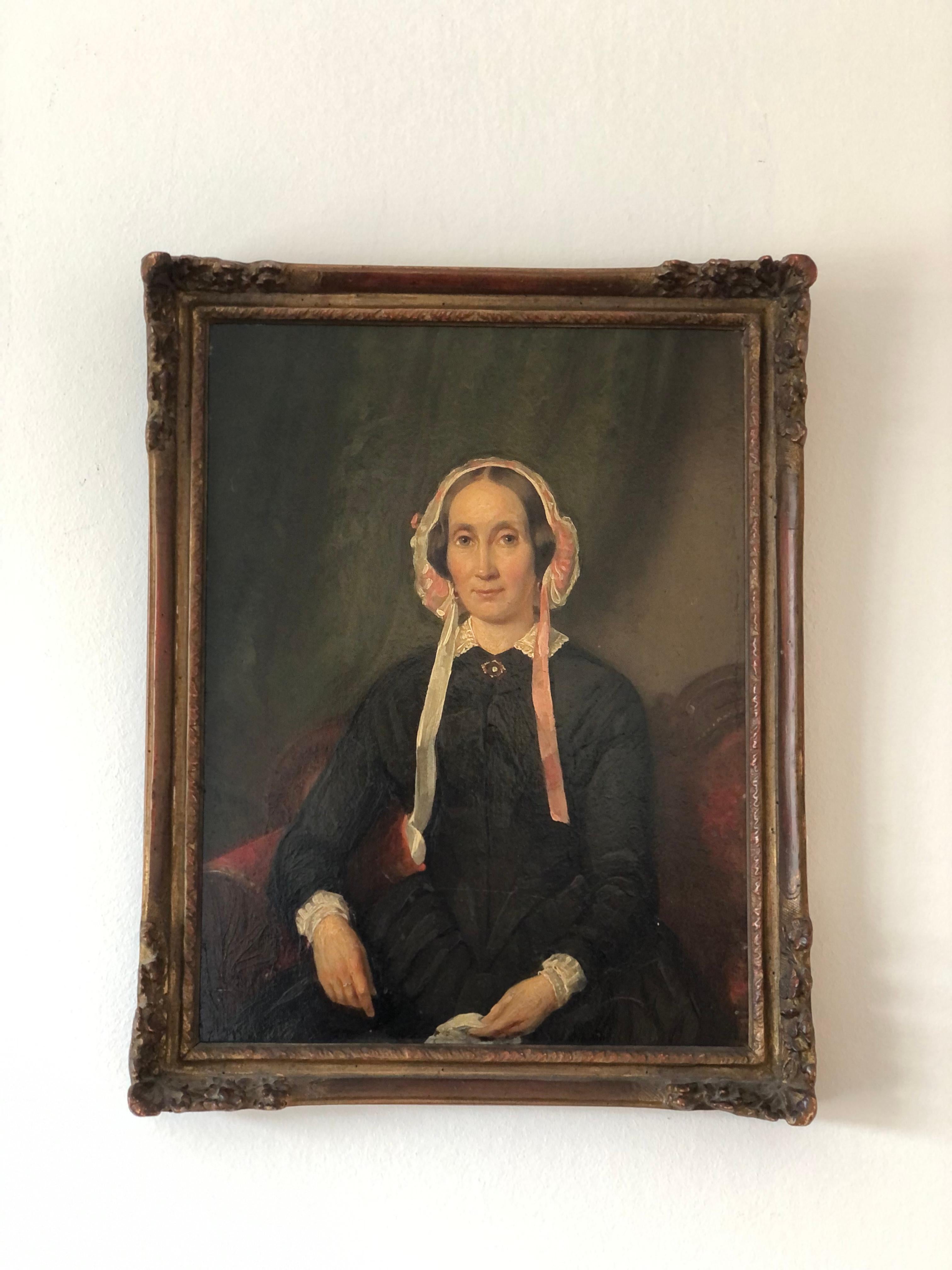 This stunning 19th-century oil portrait captures the elegance of Aukje Keizer (1807-1890), the wife of esteemed doctor Dr. Dirk de Vries Reilingh (see other listing). Dressed in classic traditional Dutch attire, Aukje wears a Dutch white and pink