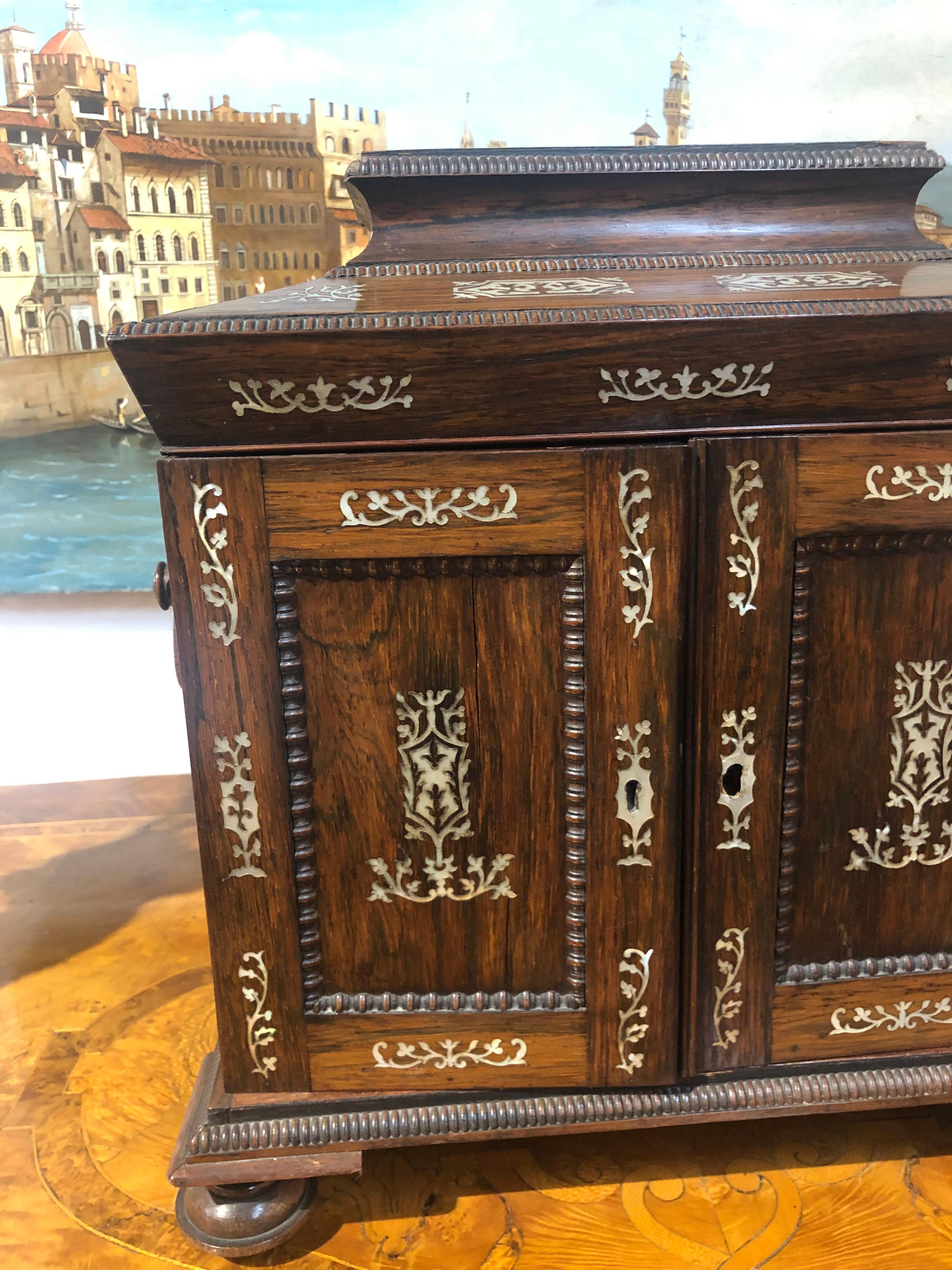 Beautiful antique Portuguese rosewood table cabinet with inlaid bone The inside of the box has a mirror and several small drawers. Lovely intricate details. Would make an excellent jewelry box for that special someone!