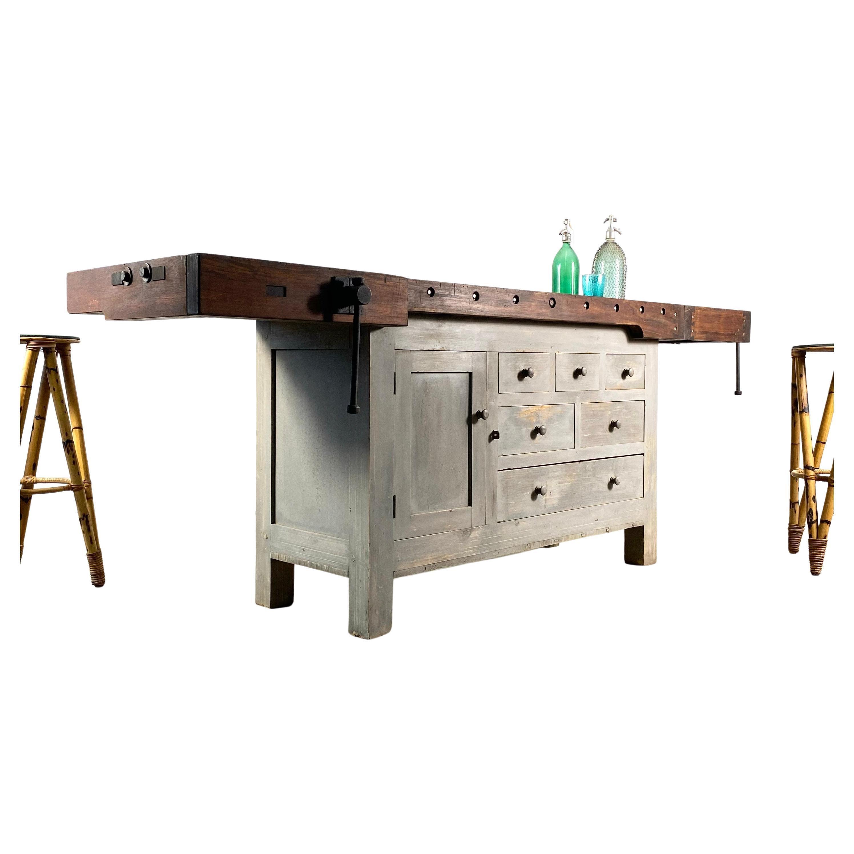 This is an unusual find for us. This 1930s workbench has a teak top with a grey / blue base. Sourced from Portugal, it has been beautifully made with over engineered dovetail components and lovely lines and details that really, are unnecessary for a