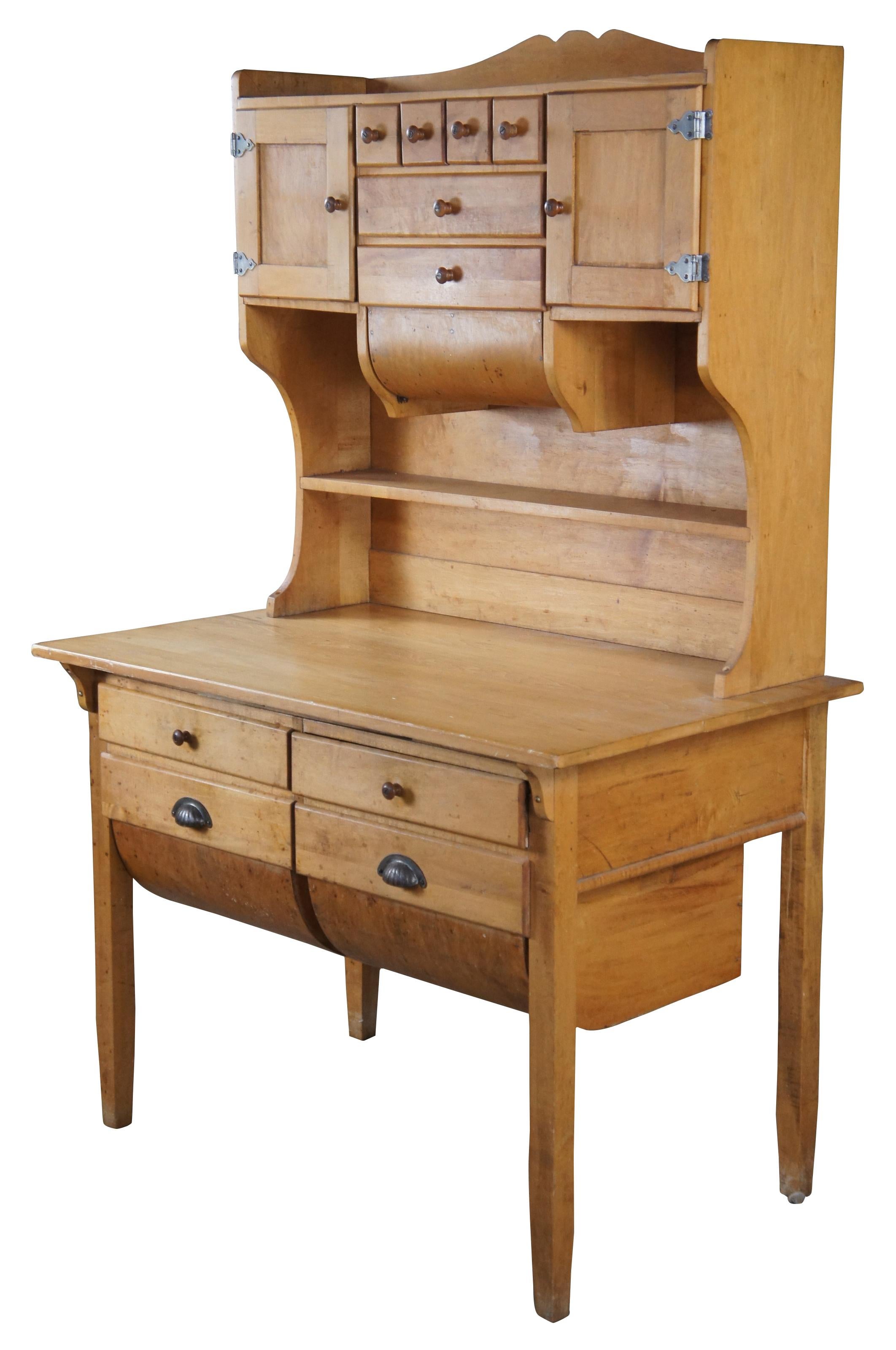 Antique Possum Belly Hoosier Bakers cabinet / cupboard or stepback hutch. Made of maple featuring various drawers, cabinets and shelf, with a large work surface featuring an additional pull out, lower drawers, and a double lower Possum Belly