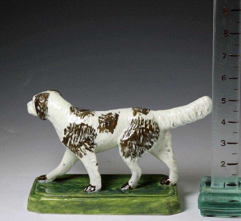 British Antique pottery figure of a setter dog standing on a base