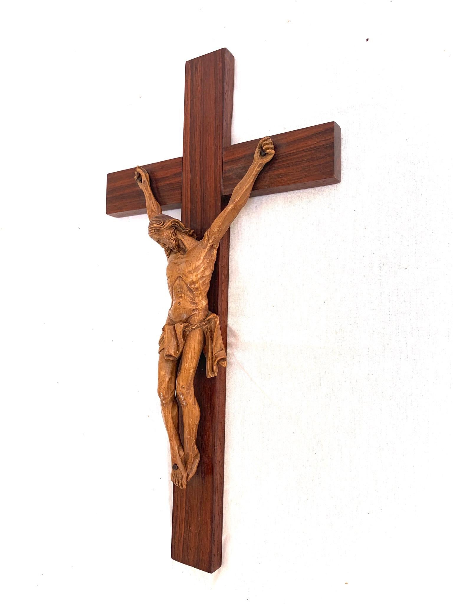 Another finely detailed, early 1900s coromandel wooden cross with a carved corpus of Christ.

This sacred and religious work of art is a hand-carved out of fruitwood Christ mounted on an wooden cross and this fine and detailed example is in