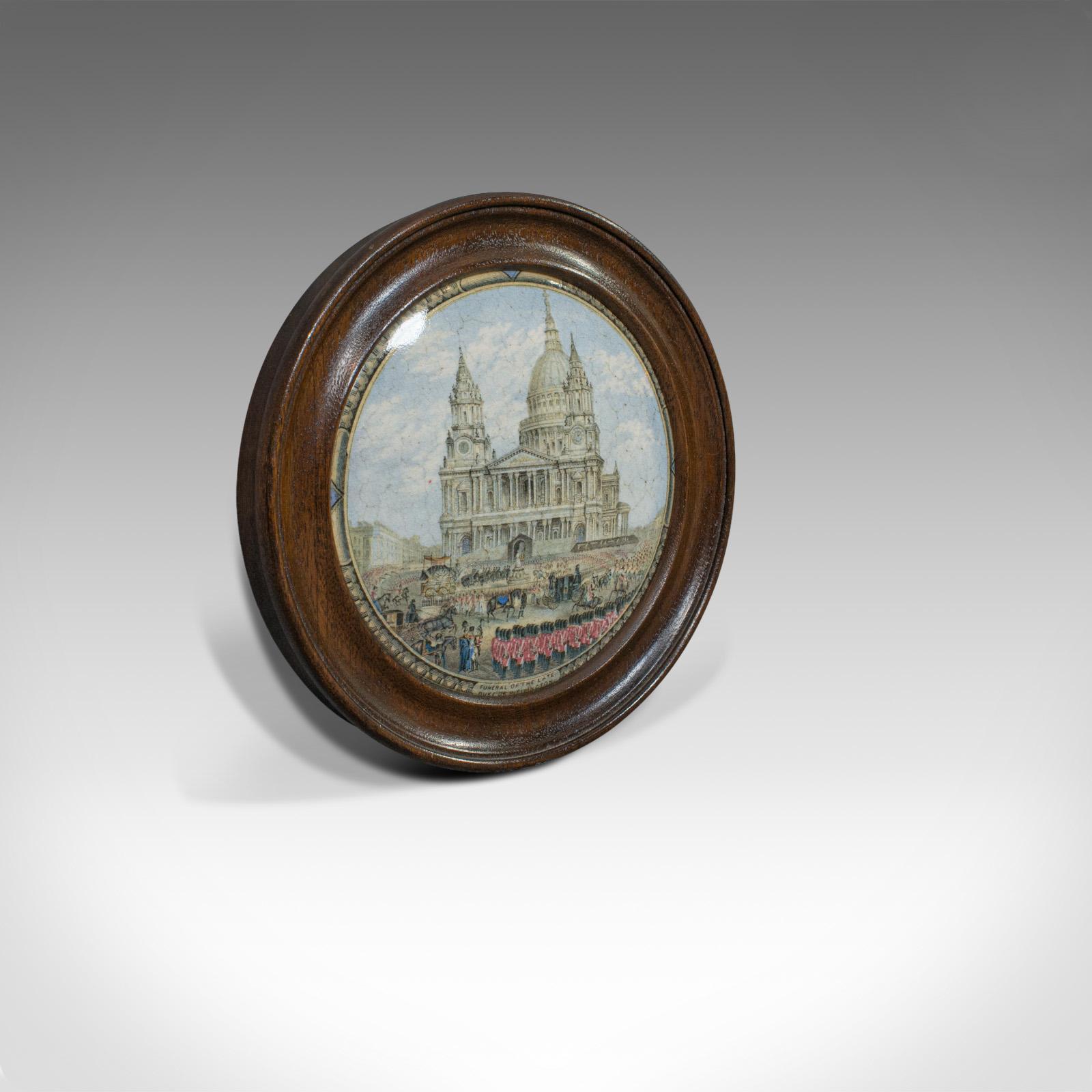 This is an antique Prattware jar lid. An English, mahogany and colour printed ceramic featuring a scene from the Duke of Wellington's funeral and dating to the Victorian period, circa 1860.

In fine form and displaying a desirable aged