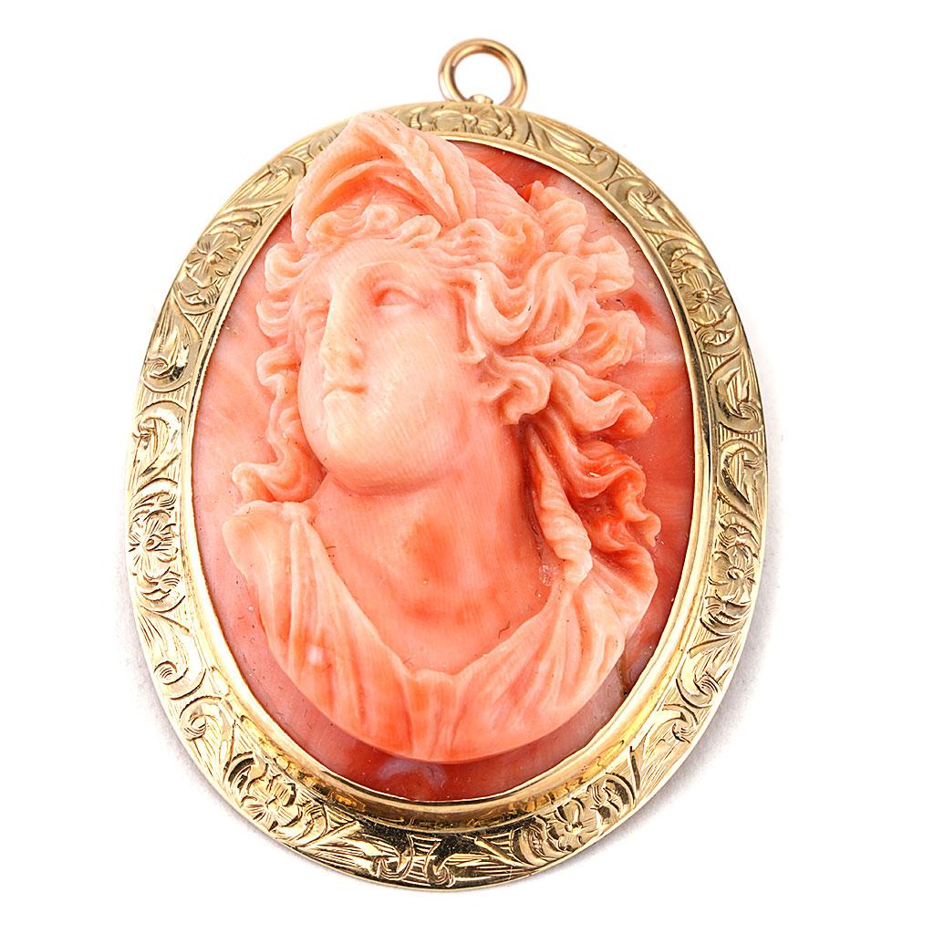 This antique coral cameo pin is made of 14K yellow gold and dates back to Circa 1970.