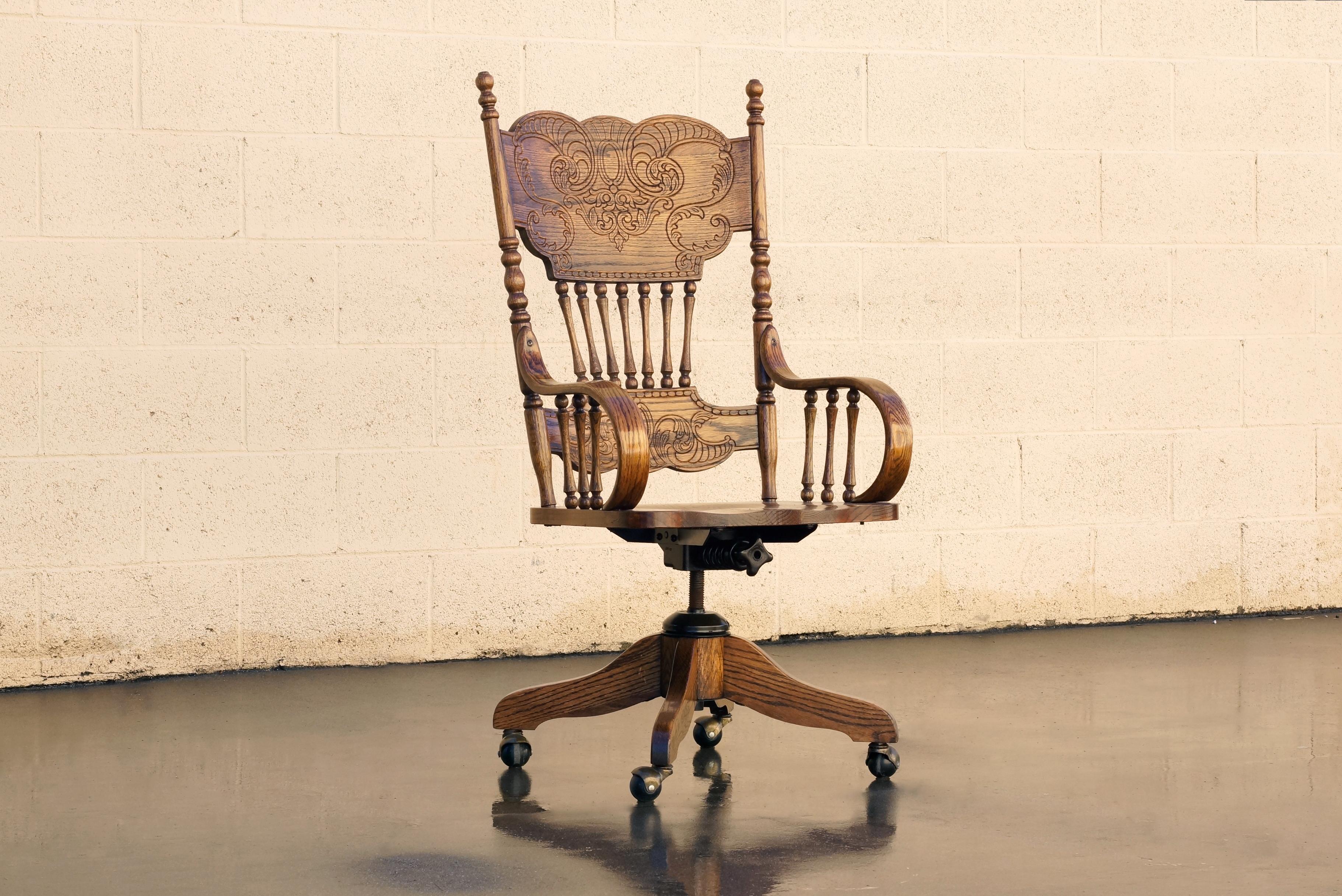 Antique oak steno chair with wonderful press back design. This beautifully crafted seat also features thick bentwood arms, spindles, hooded casters and original steel hardware. In excellent condition with a golden oak patina; reconditioned wood.