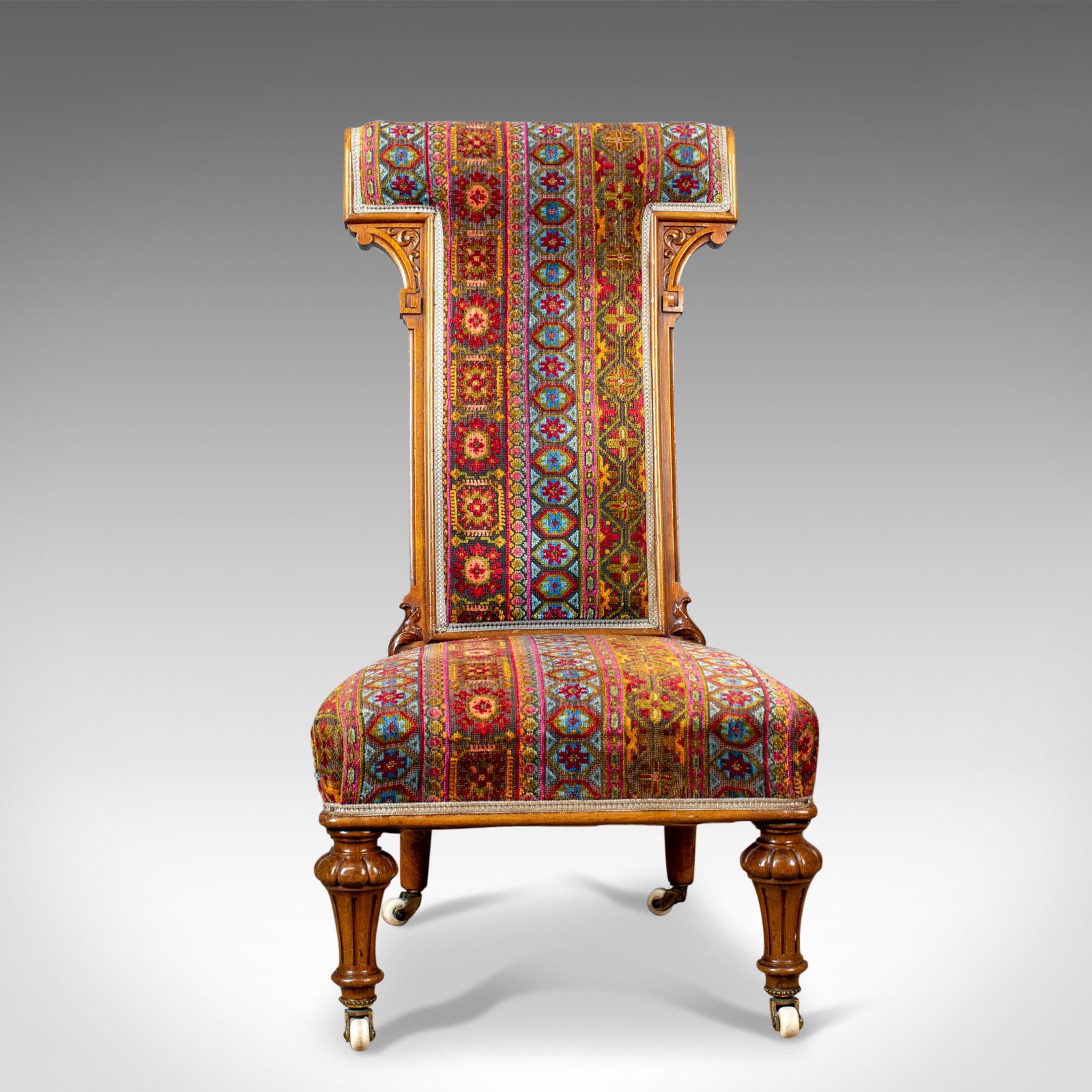 This is an antique prie dieu chair, a 19th century, regency chair in walnut. Ideal as a bedroom side chair and dating to circa 1820. 

The walnut displaying good colour and grain interest
Raised upon well formed reeded and flared, turned front