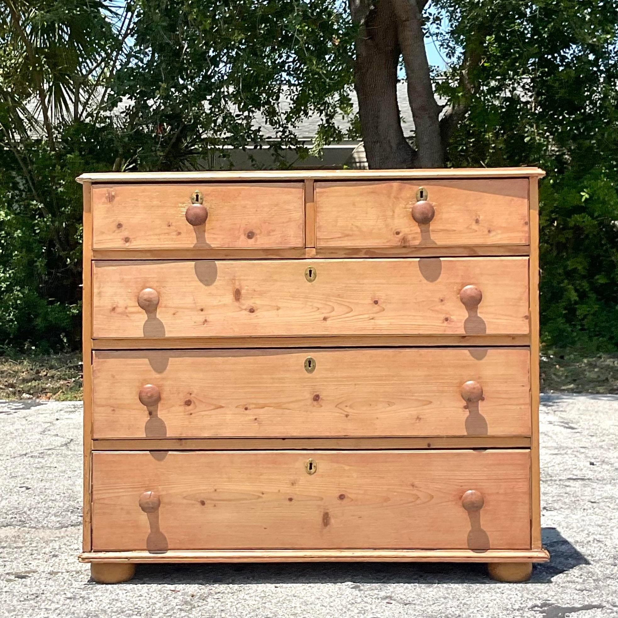 Experience the rustic charm of our Antique Primitive Pine Chest of Drawers, a timeless treasure that embodies the essence of early American craftsmanship. Crafted with sturdy pine and adorned with simple yet elegant details, this chest offers both
