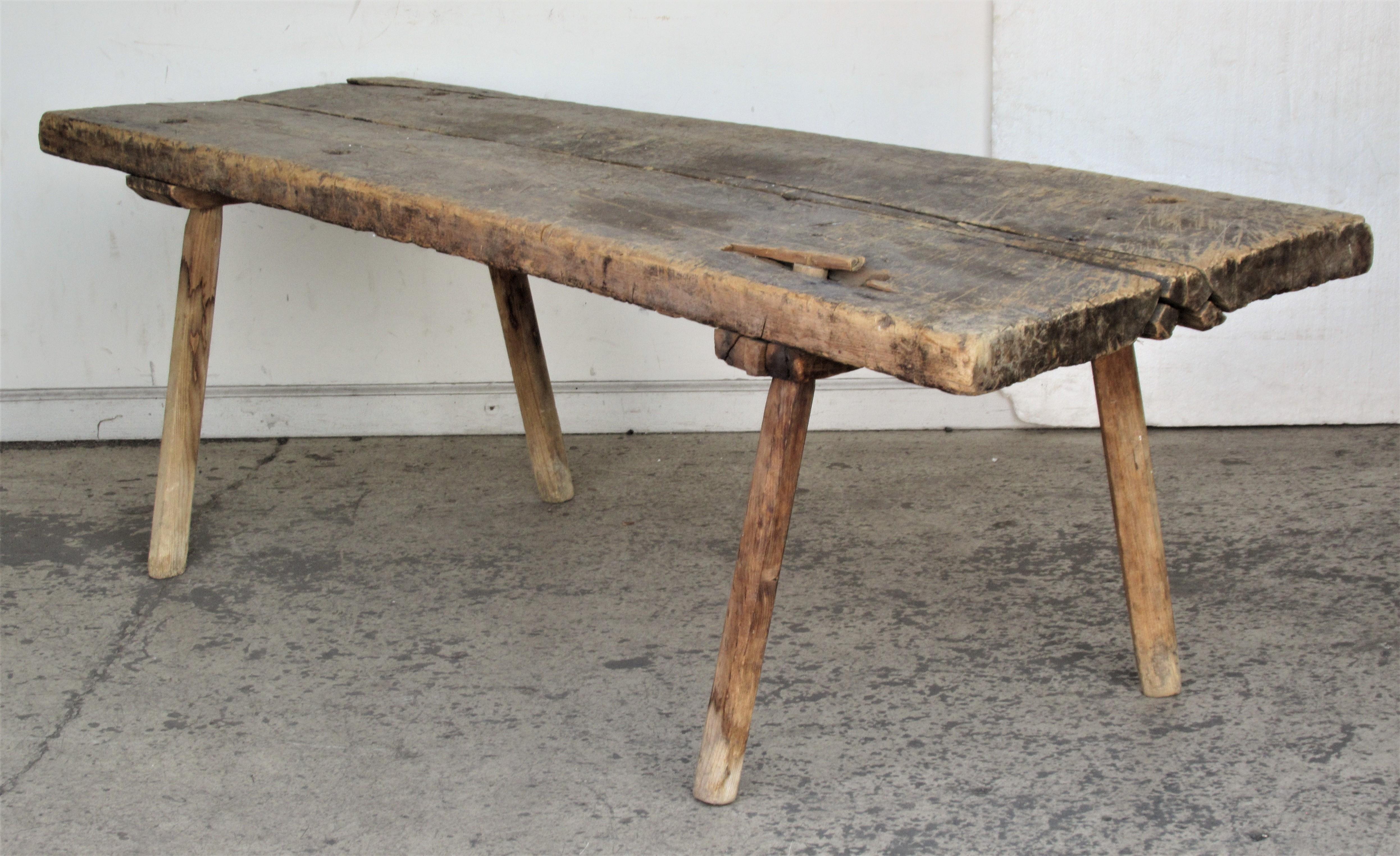 Antique 19th century American primitive butcher's table or bench with four splayed peg legs and a beautifully aged and distressed two board thick slab wood top. Look at all pictures and read condition report in comment section.