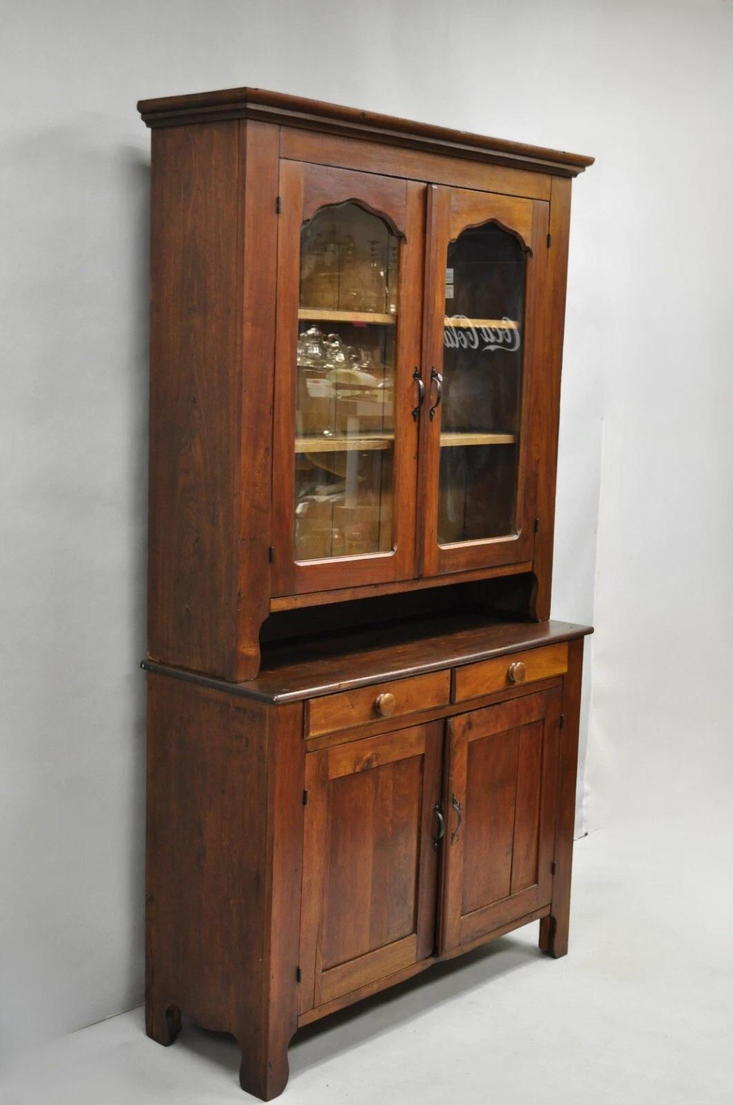 Antique Primitive Country Farmhouse Pine & Cherry Wood Hutch Cupboard China Cabinet. Item features 2 part construction, glass doors, solid wood construction, 2 drawers, fixed shelves, beautiful wood grain and patina. Circa Late 19th Century.