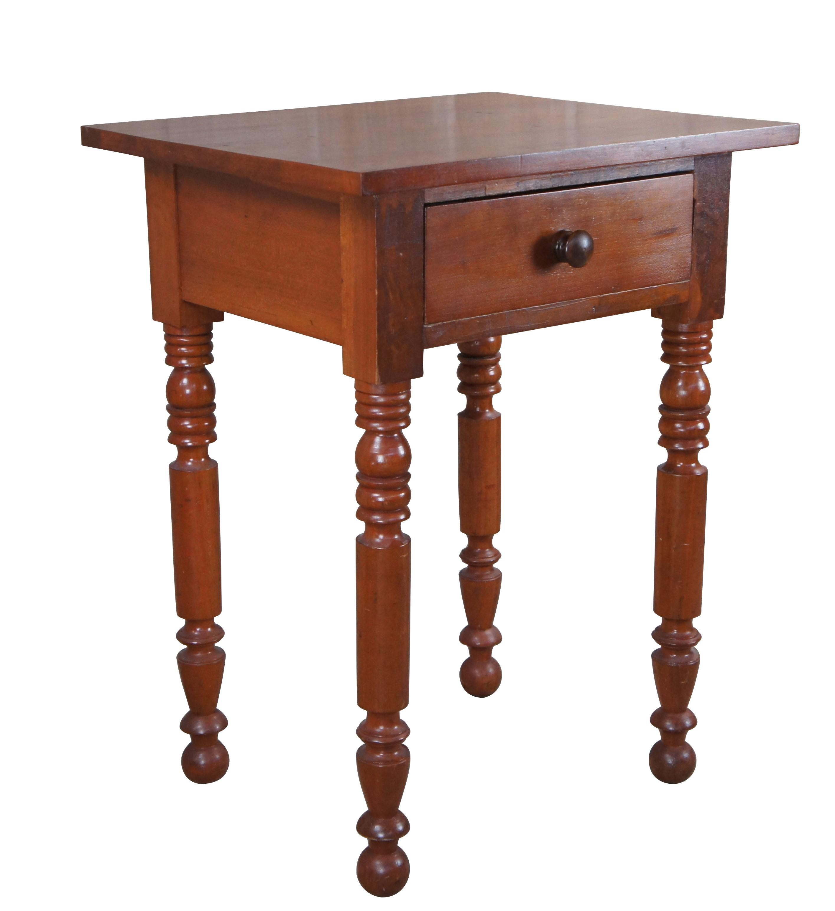Antique Early American side table. Made of cherry featuring rectangular form with one dovetailed drawer and turned legs.  Includes glass top.

Dimensions:
21.5