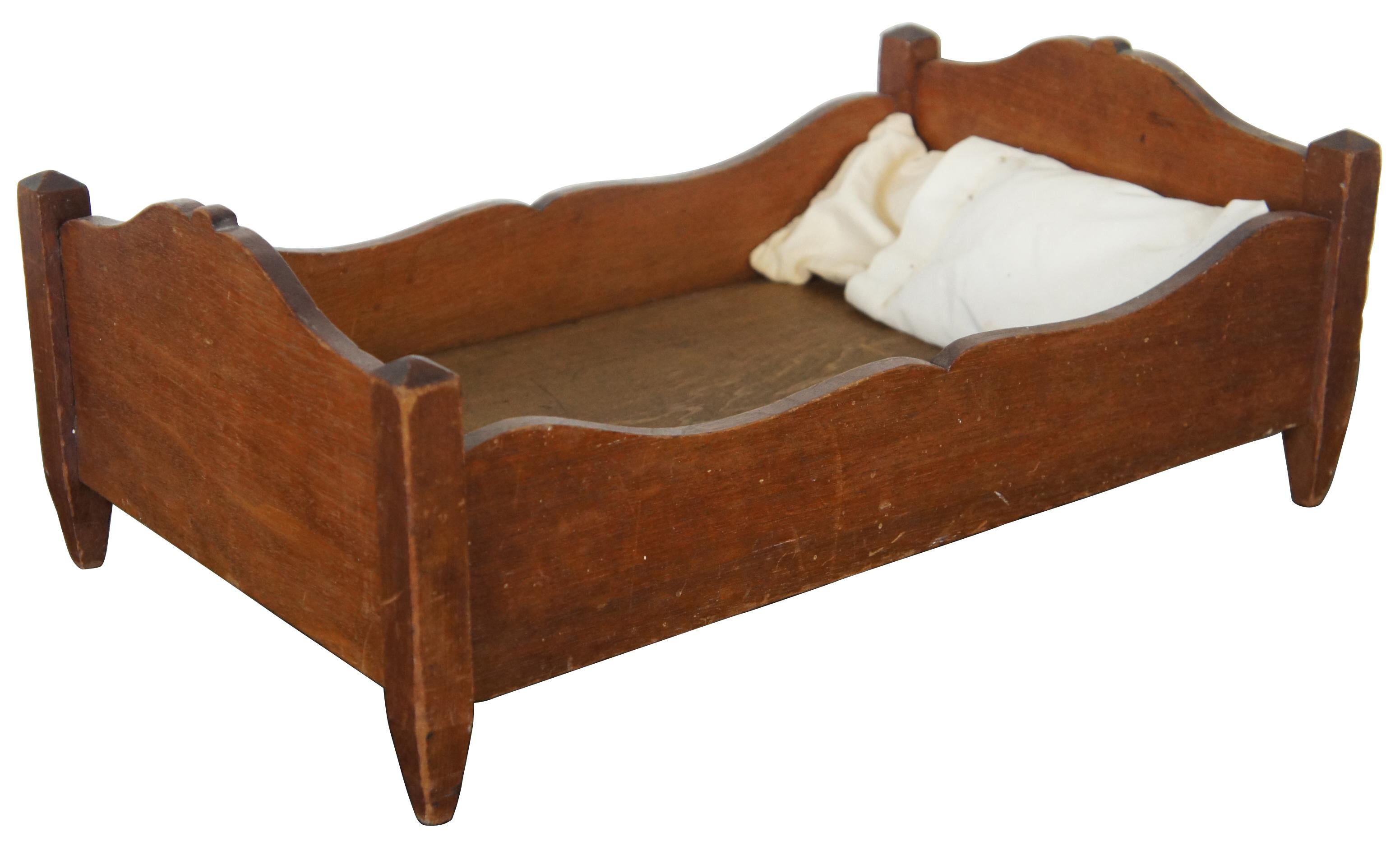Antique Primitive early American miniature salesman sample walnut bed with two pillows. Measures: 18
