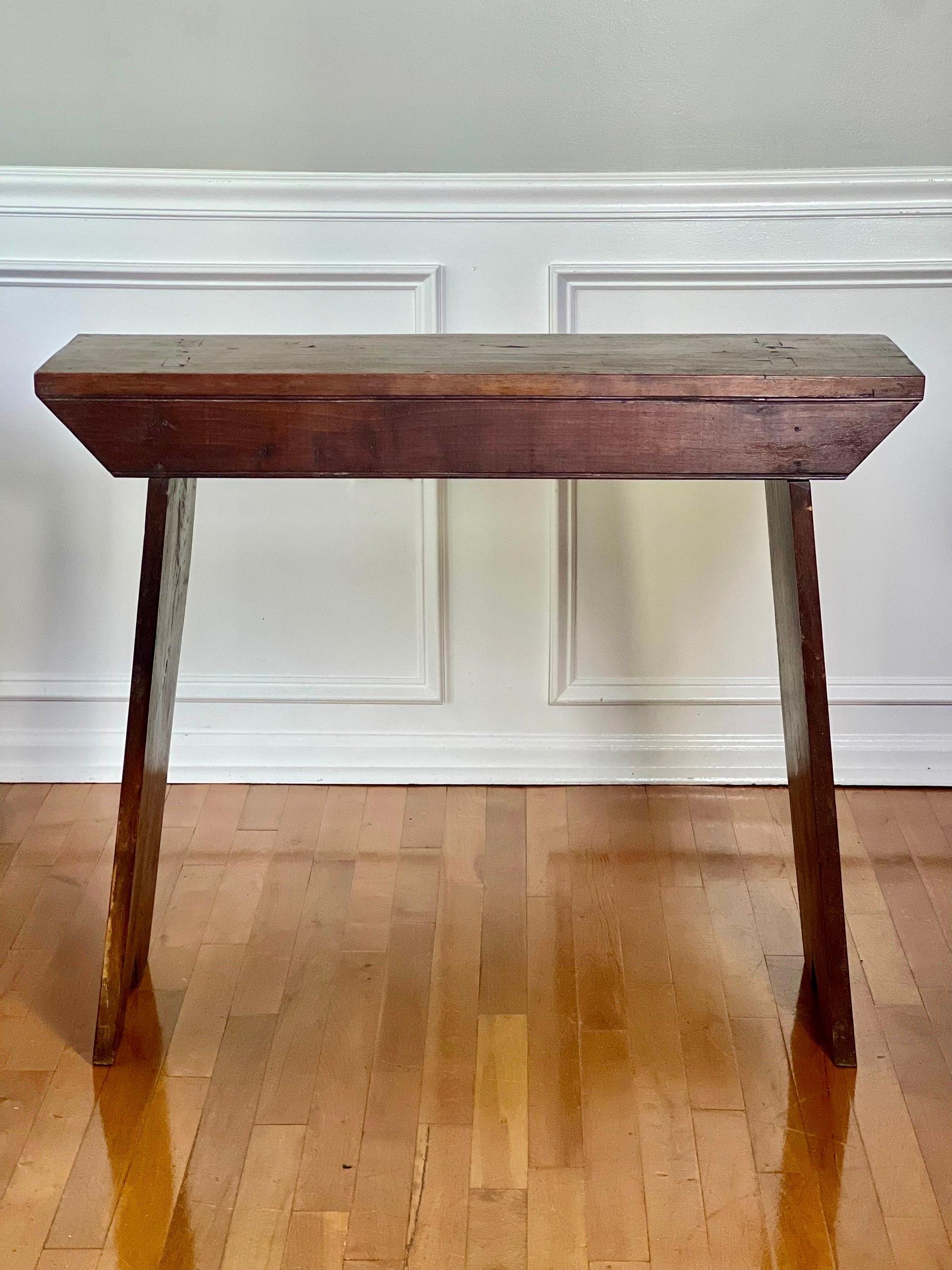 Unique, primitive hand-crafted Pennsylvania farmhouse walnut console or workbench with mortise and tenon construction, circa 1900. Beautifully simplistic in design and utilitarian in purpose having fine German craftsman influence, typically realized