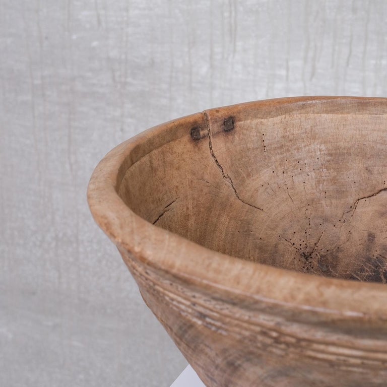 A primitive style hand made wooden bowl. 

France, c1900s. 

With lovely historical repairs on display in the form of naive iron fixings. 

From a time where an item was repaired to extend it's life, and indeed now is full of character.