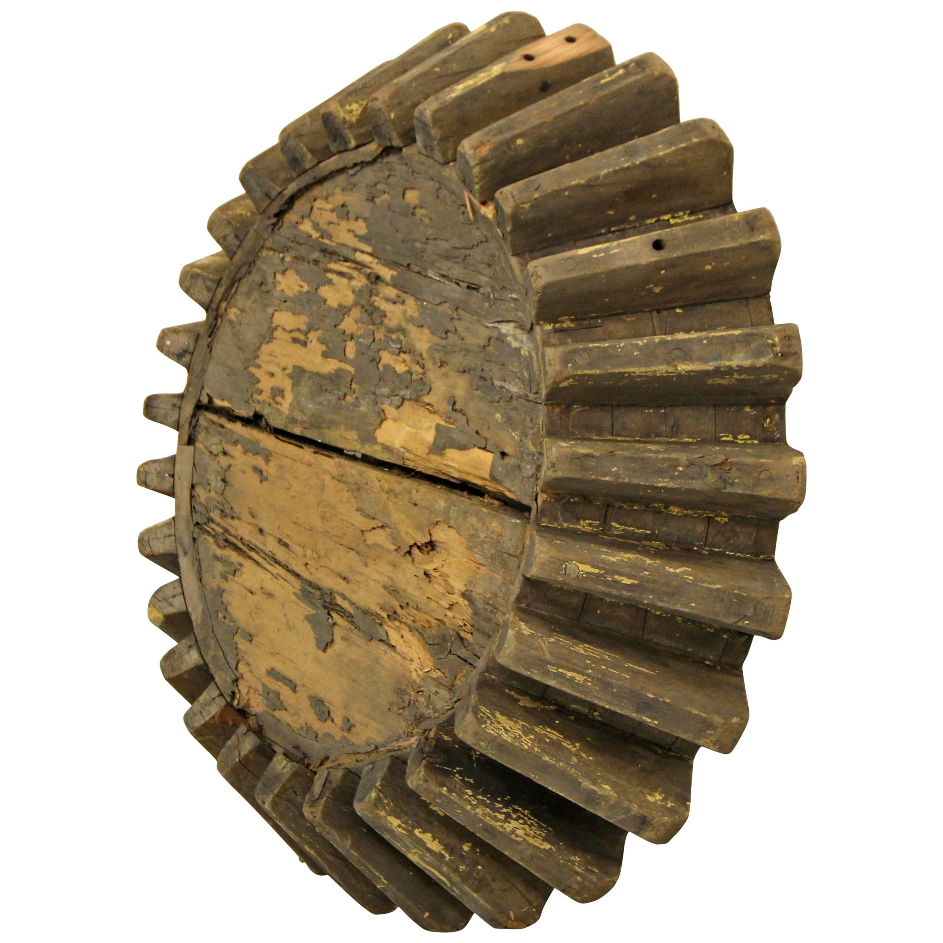 Dating from the late 1800s-early 1900s, this antique wooden mill gear is a real piece of art. This piece could really serve many purposes, as art it can be hung or placed somewhere, it would also make an excellent coffee table base, just add a piece