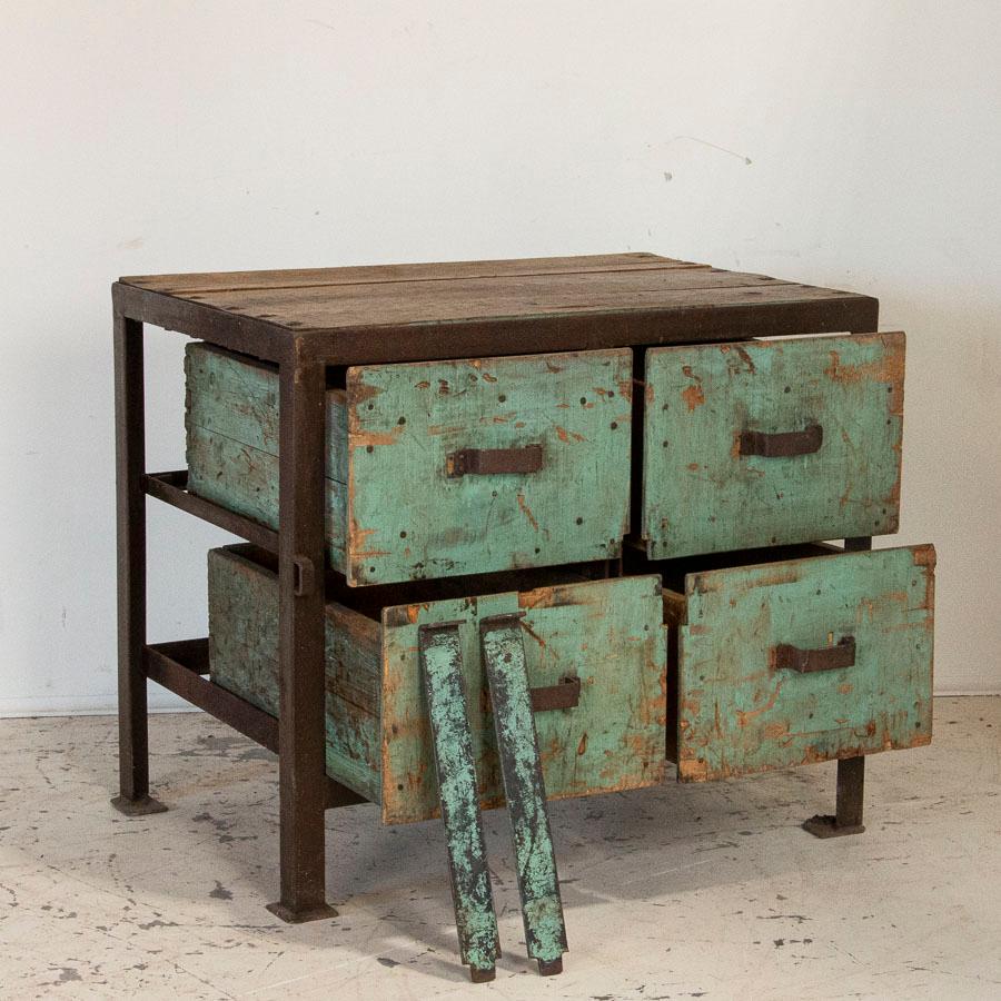 Fun, funky and functional, this old work table is loaded with character. The iron frame is heavy and solid, supporting the 4 large drawers which are secured in place by 2 flat metal rods. Both the drawers and sliding/removeable metal rods still