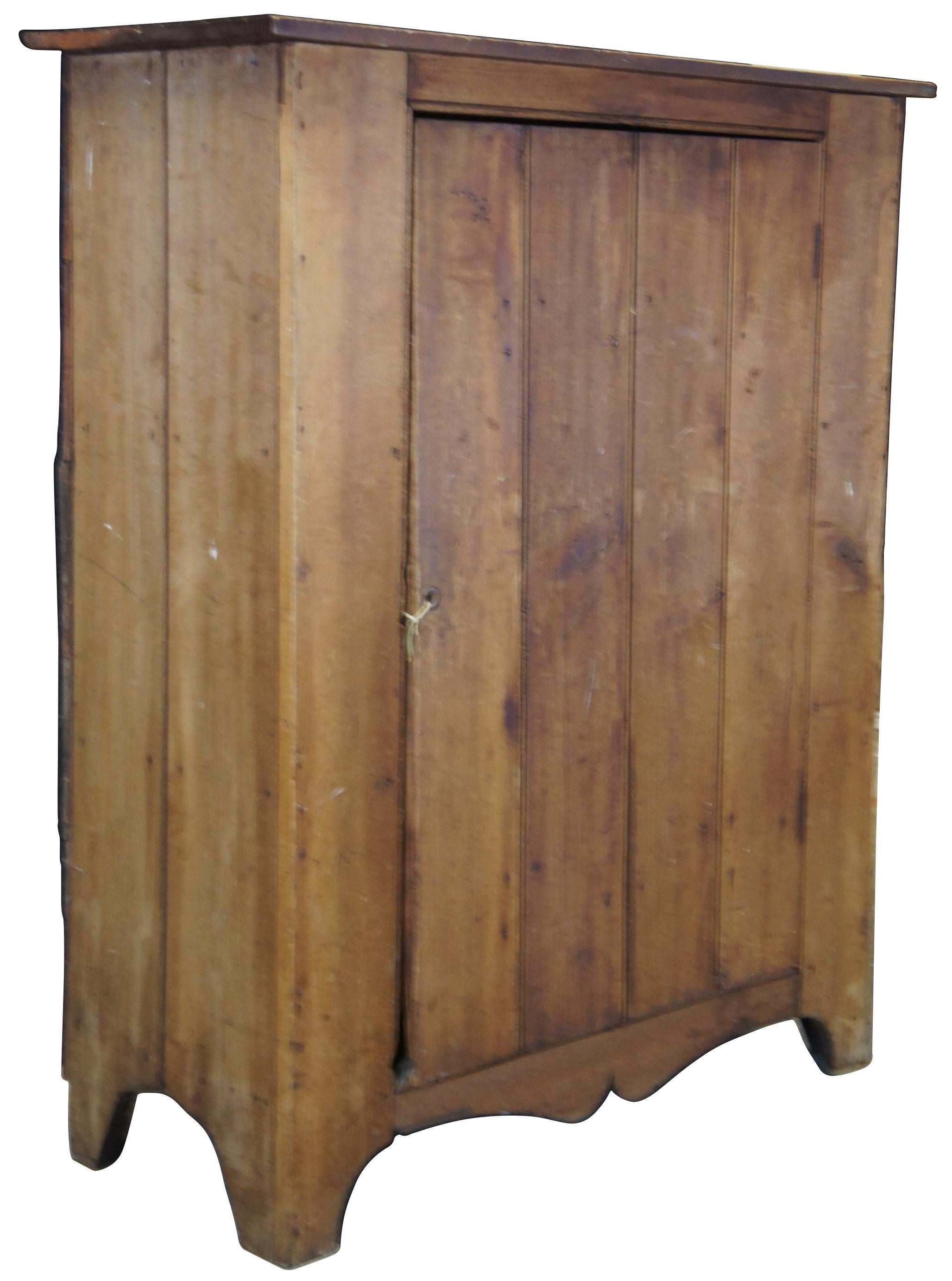 Antique 19th century Pennylvania Pine jelly cabinet or cupboard. Features a low profile withe large door that opens to three shelves.
    