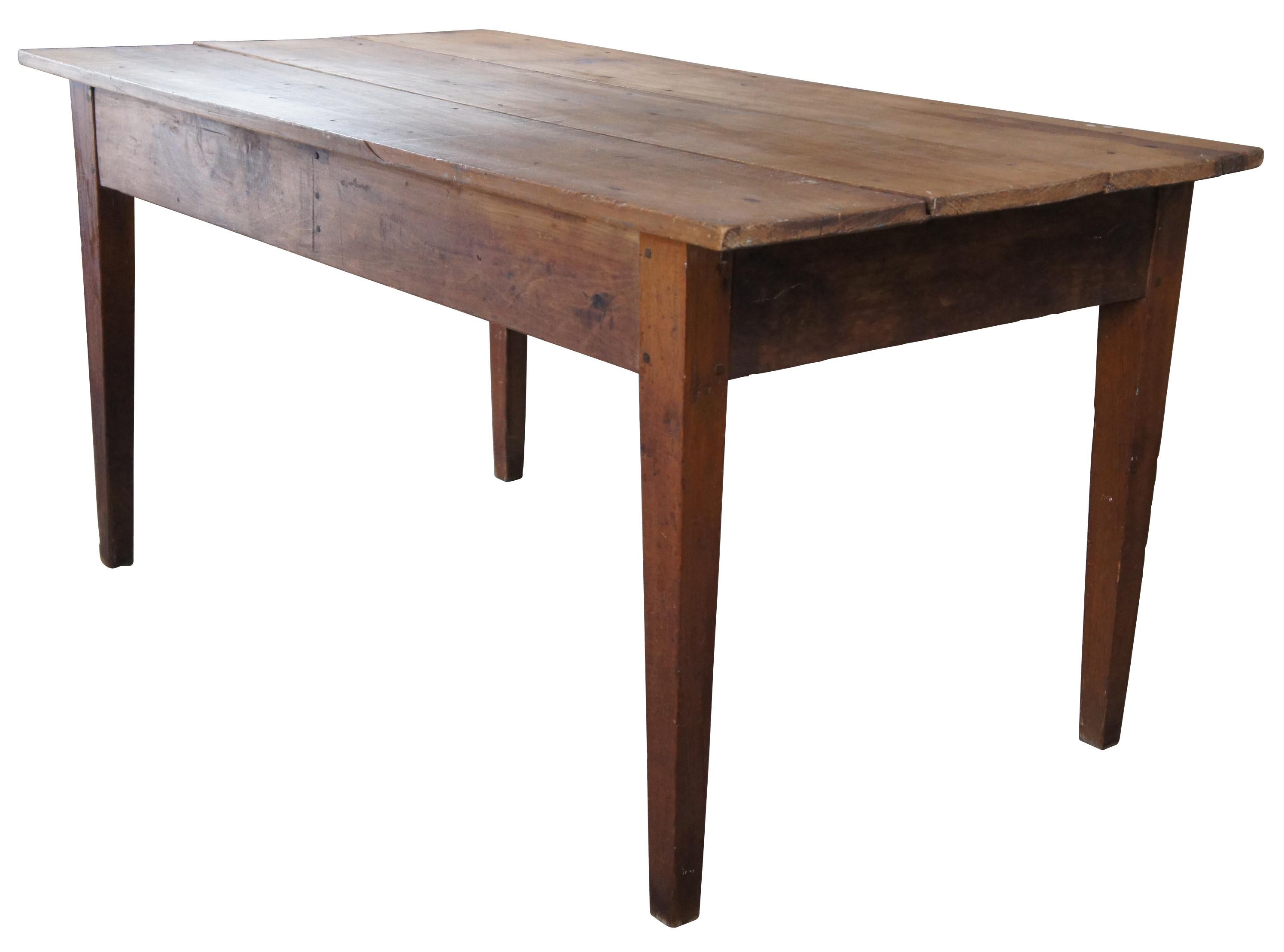 Antique primitive Tennessee farm house breakfast / dining table or desk. Made of pine planks featuring rectangular form with a three plank top and square tapered legs.