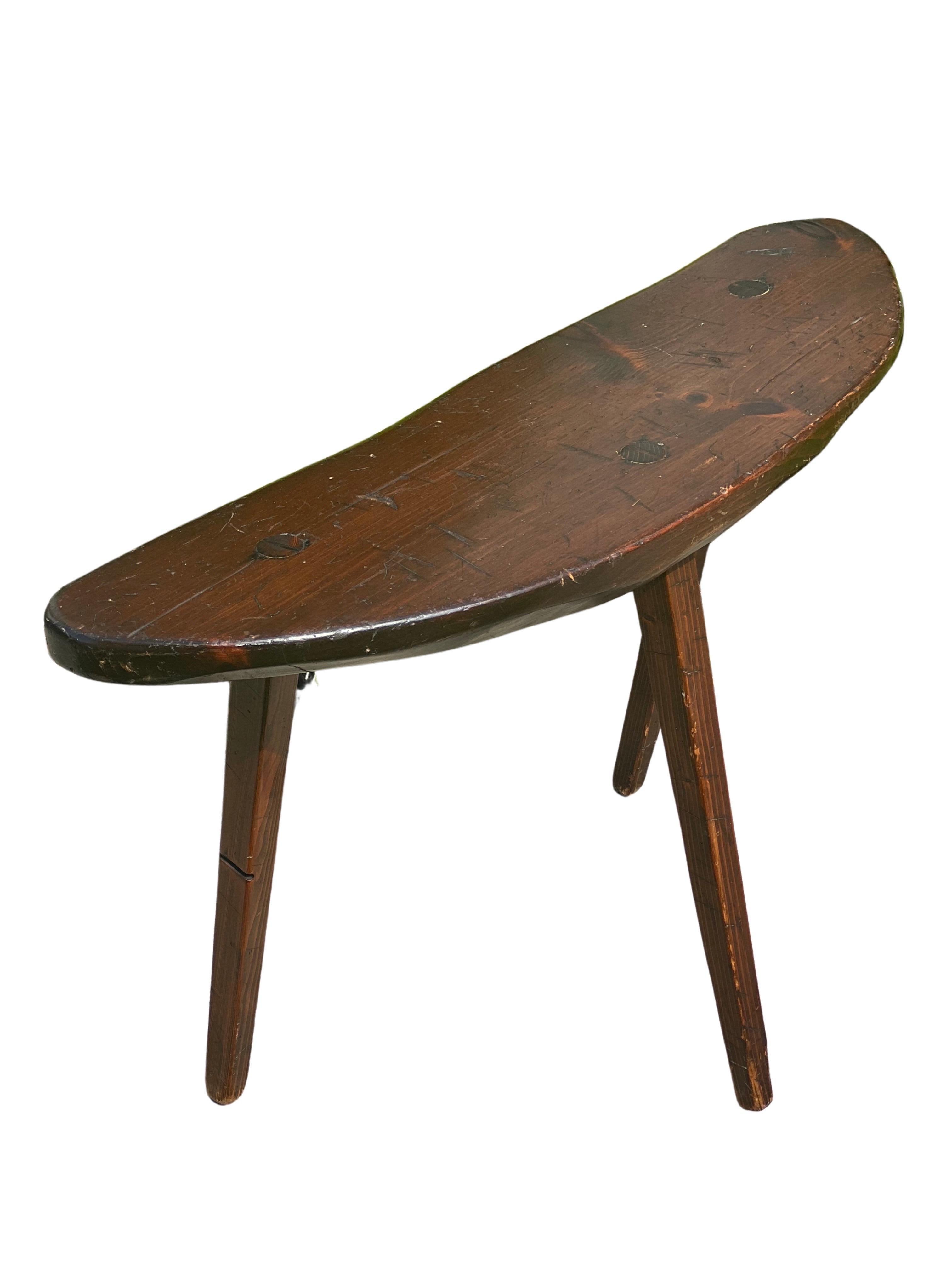Antique primitive organic from side table on three splayed legs, c. late 19th century. 

One-of-a-kind, handcrafted side table with an organic, crescent-shaped walnut top. Wonderful, uniform patina and live edge detail lend dimension and depth to