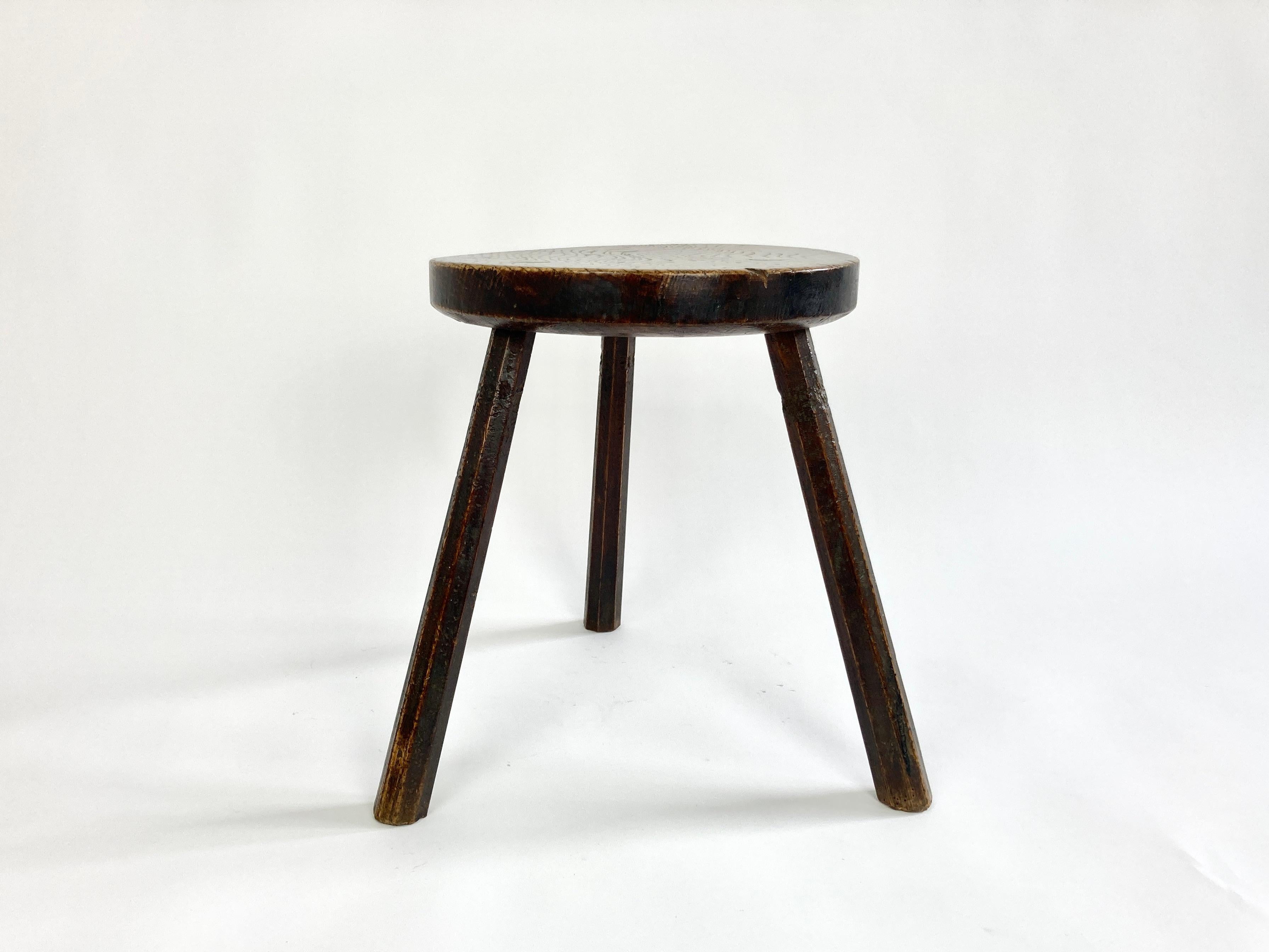 Rustic tripod stool made of elm dating from the late 19th / early 20th century.

Acquired from a small farm in South West Wales, the previous owner recalls it from her childhood and remembers being told stories about it which go back to at least