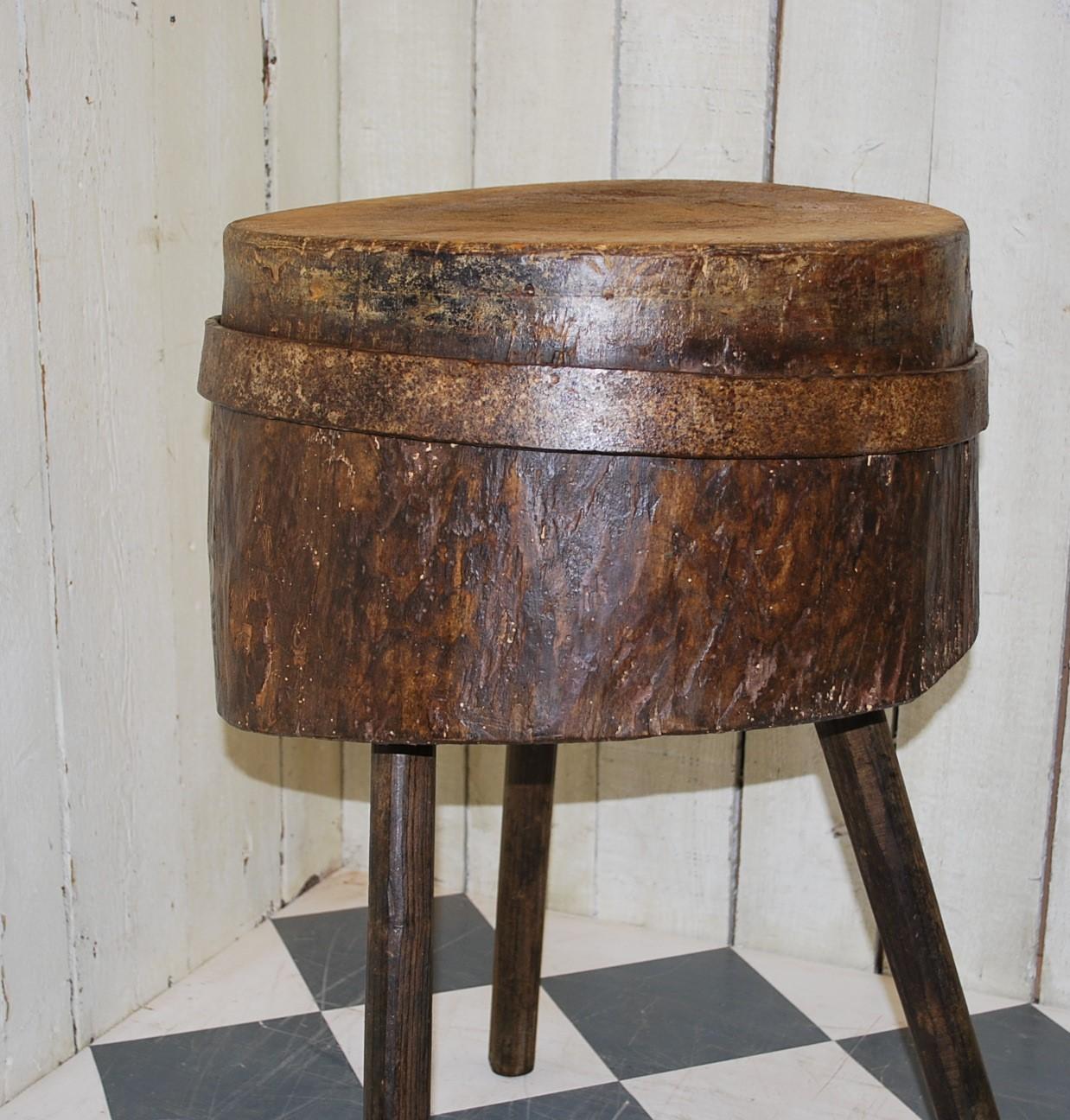 Unusual primitive tripod chopping block or occasional table. Standing on three chamfered legs set into a thick section of trunk with a blacksmith made band placed around the exterior. Great as a lamp table in a modern or period table. A real talking