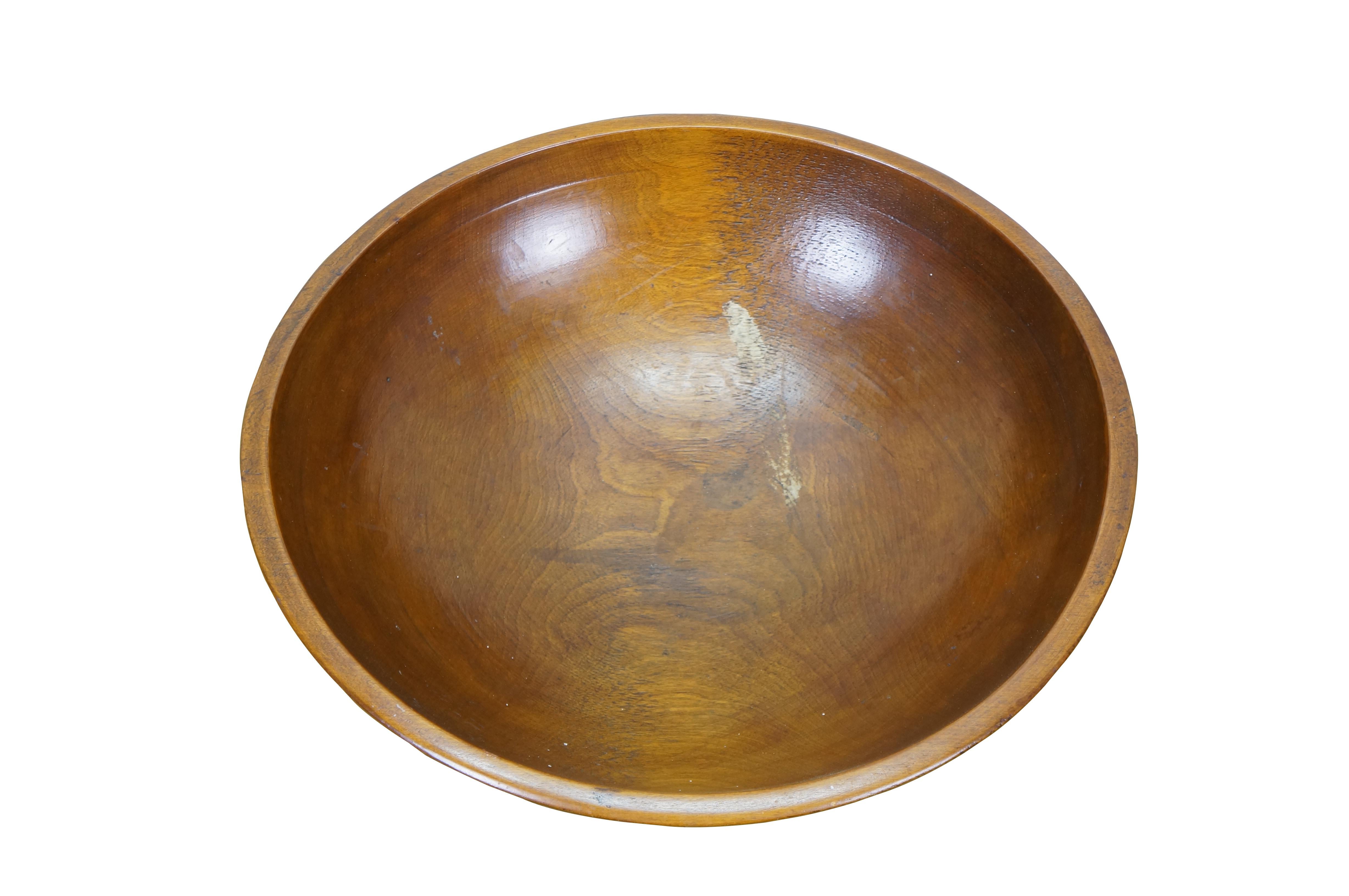 Large antique folk art country farmhouse dough mixing or centerpiece fruit bowl.  Made of turned maple wood featuring a slightly ovular form with banded lip and a nice, glossy finish.

Dimensions:
17.75