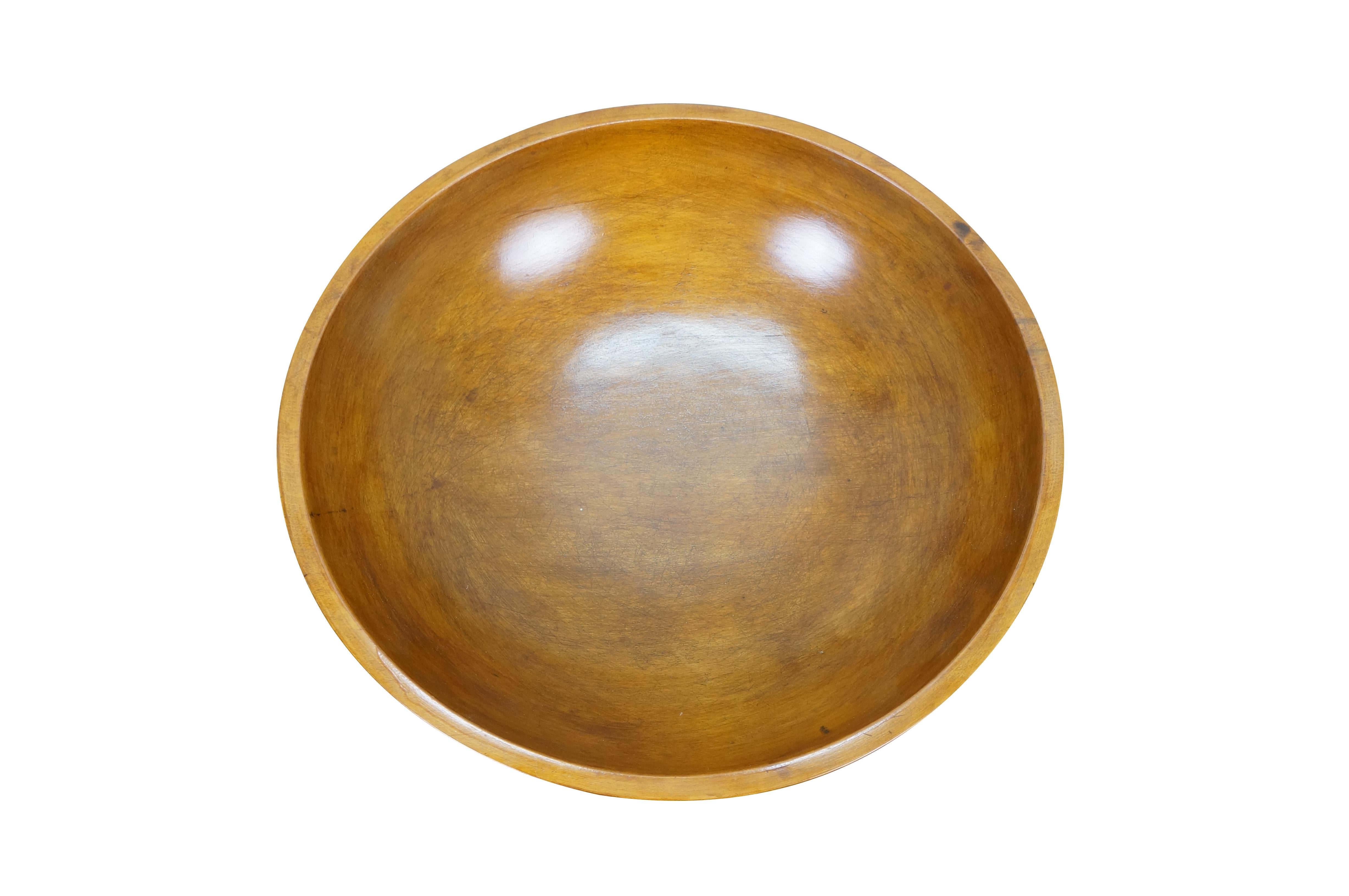 Antique folk art country farmhouse dough mixing or centerpiece fruit bowl.  Made of turned maple wood featuring a slightly ovular form with banded lip and a nice, glossy finish.

Dimensions:
15