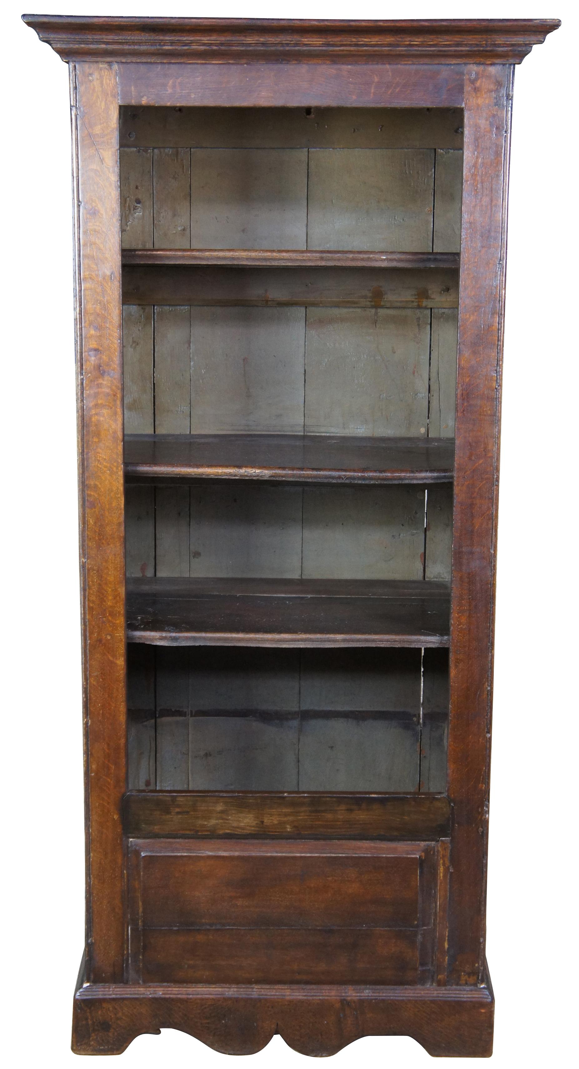 Primitive 18th century Welsh oak bookshelf or cabinet. Features three interior shelves, internal compartment, and paneled exterior. Measure: 72