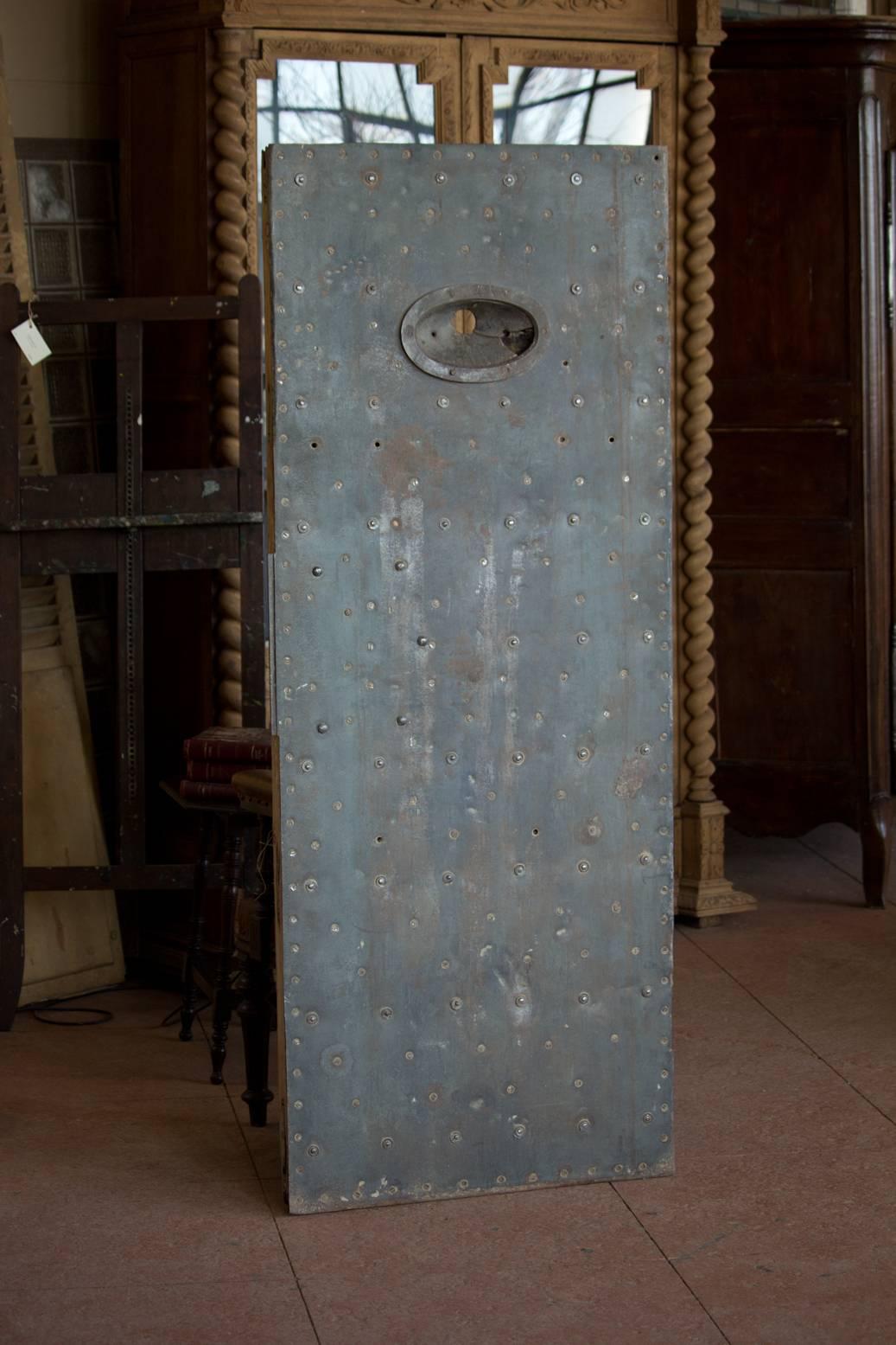 Rare antique stripped and polished metal door front, from H.M. Shepton Mallet prison. The studded wooden back has hand forged bolts. Macabre and very interesting, certainly a piece with lots of history!