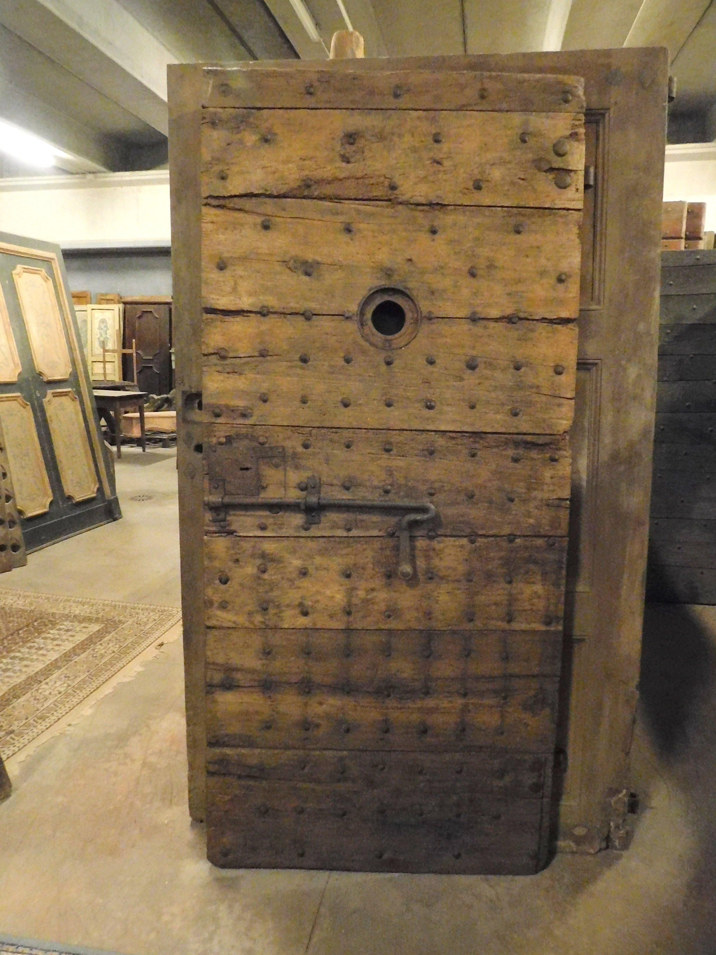 Ancient prison door in brown poplar, beautiful patina of centuries-old, still with original irons and locks, built entirely by hand in the 19th century for a castle prison in northern Italy
Size: cm W 94 x H 207 x D 6, perfect for a wine cellar,