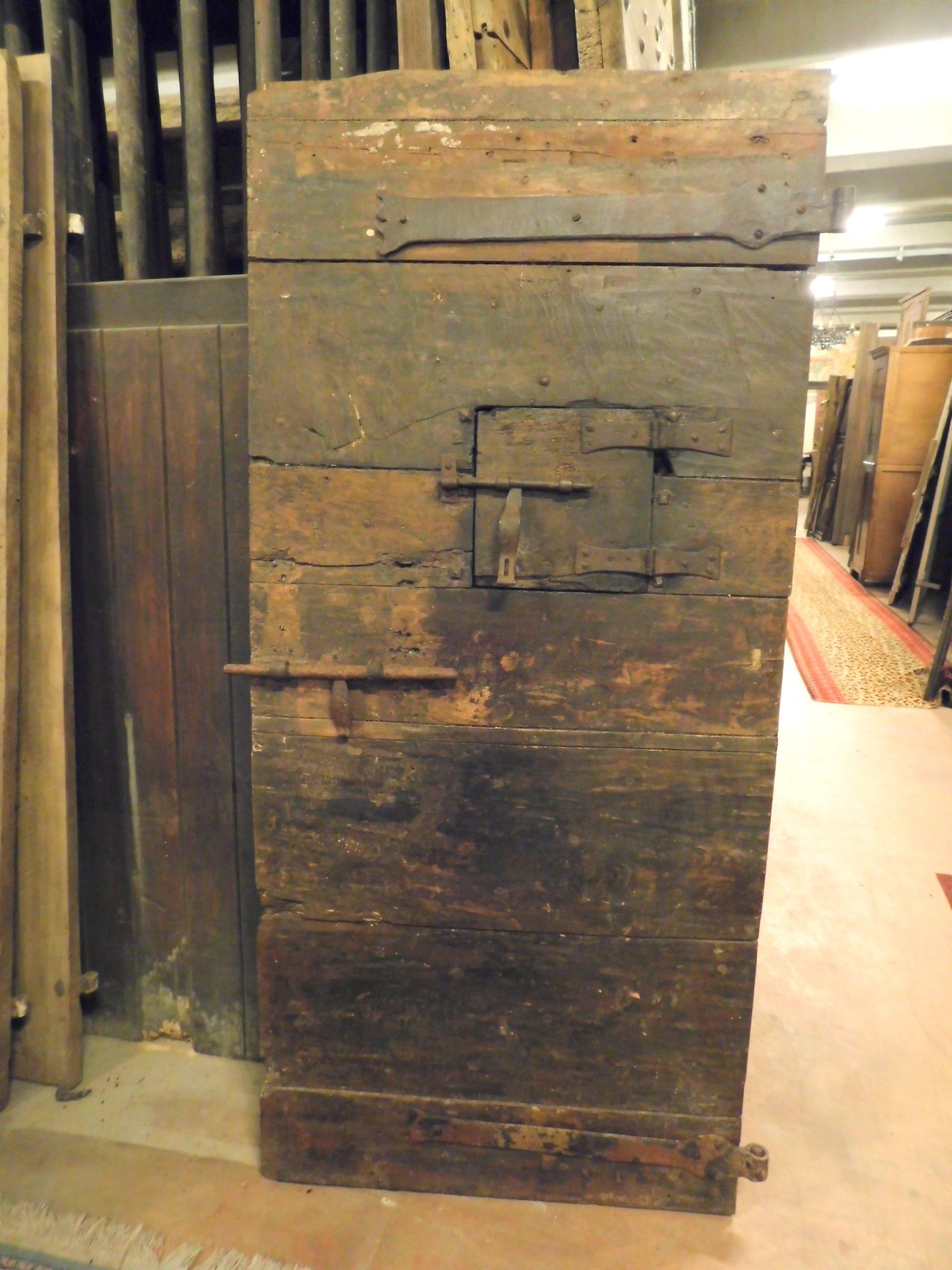 Ancient prison door in poplar with a beautiful dark patina, has original window to look inside and irons for the wall, all original, smooth back and in good conservative condition, handmade at the beginning of the 18th century in Italy.
Perfect for