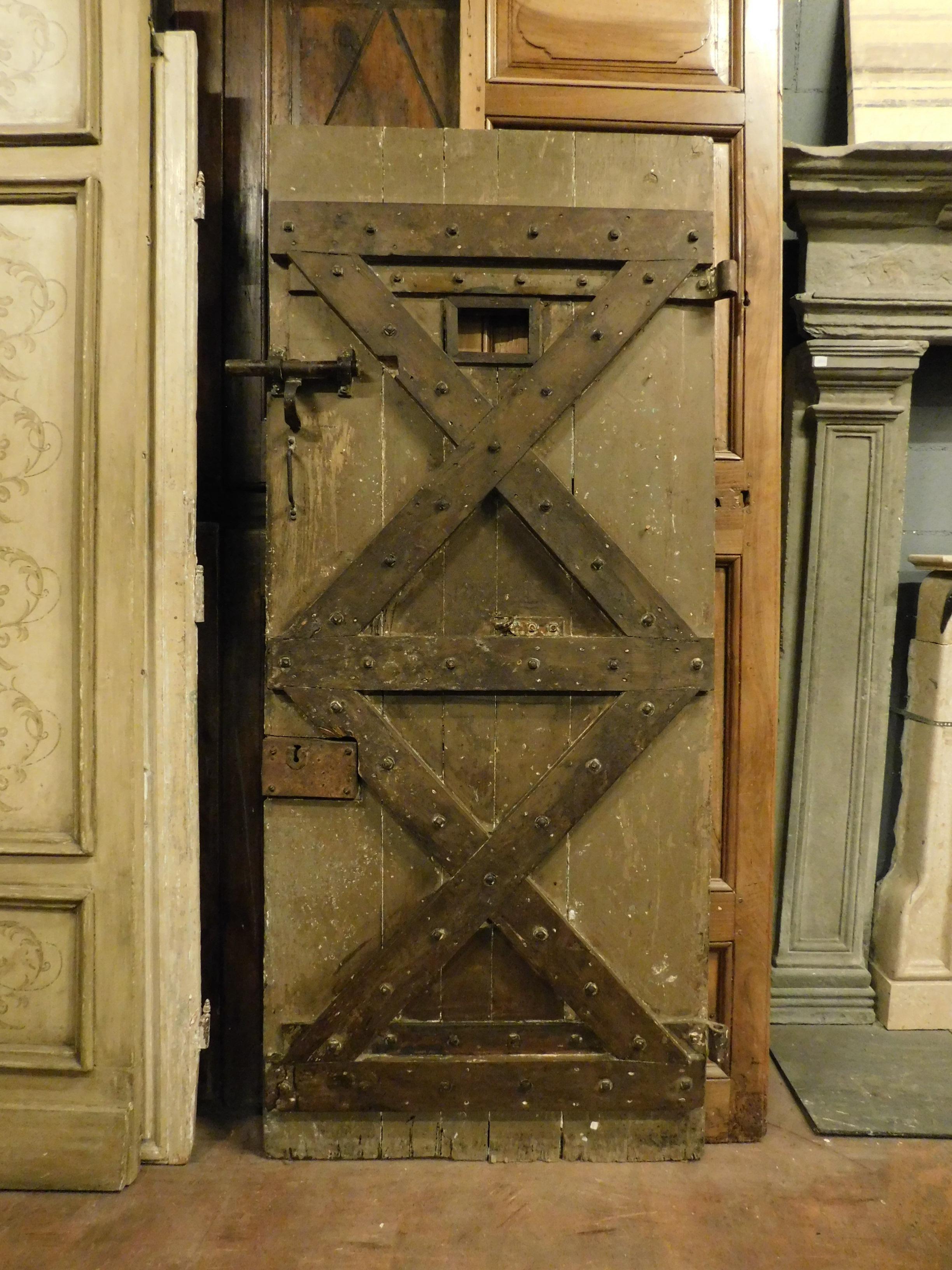 Ancient hand-lacquered prison door, in original first lacquer and with original irons (opening to pull from the right), typically sculpted with a cross on the front and a small window, built entirely by hand in the 19th century, for prison in