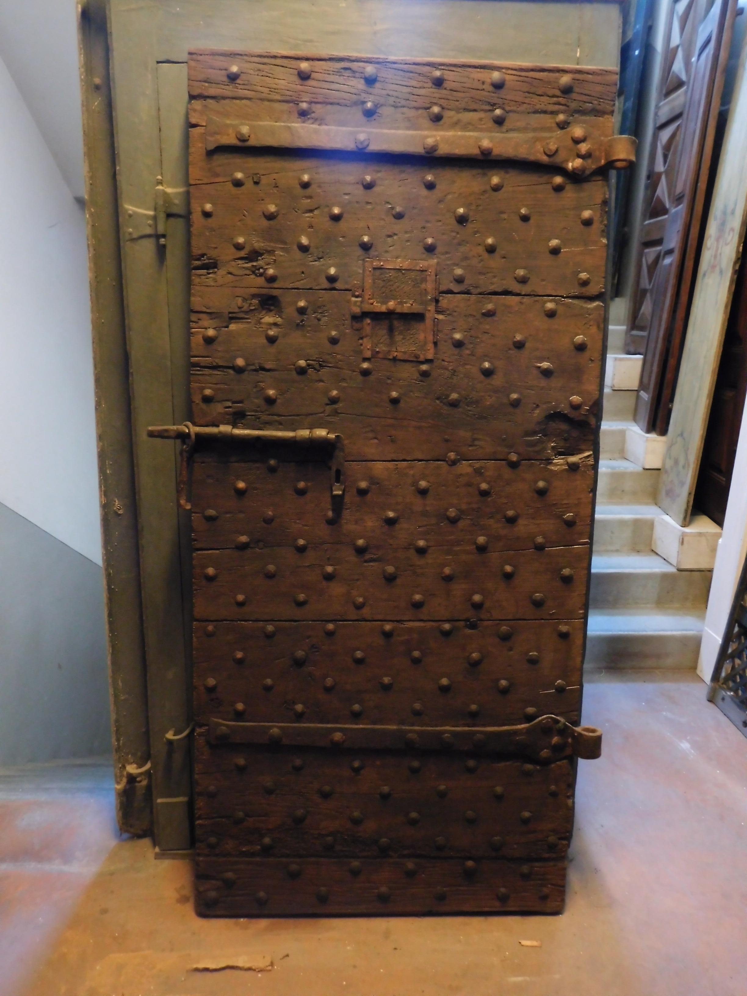 Ancient prison door with small peephole, it has kept the original irons and the locks clearly visible and massive, it comes from a castle of the 18th century, in Italy.
Beautiful and impressive, perfect for a wine cellar or a garage with an ancient