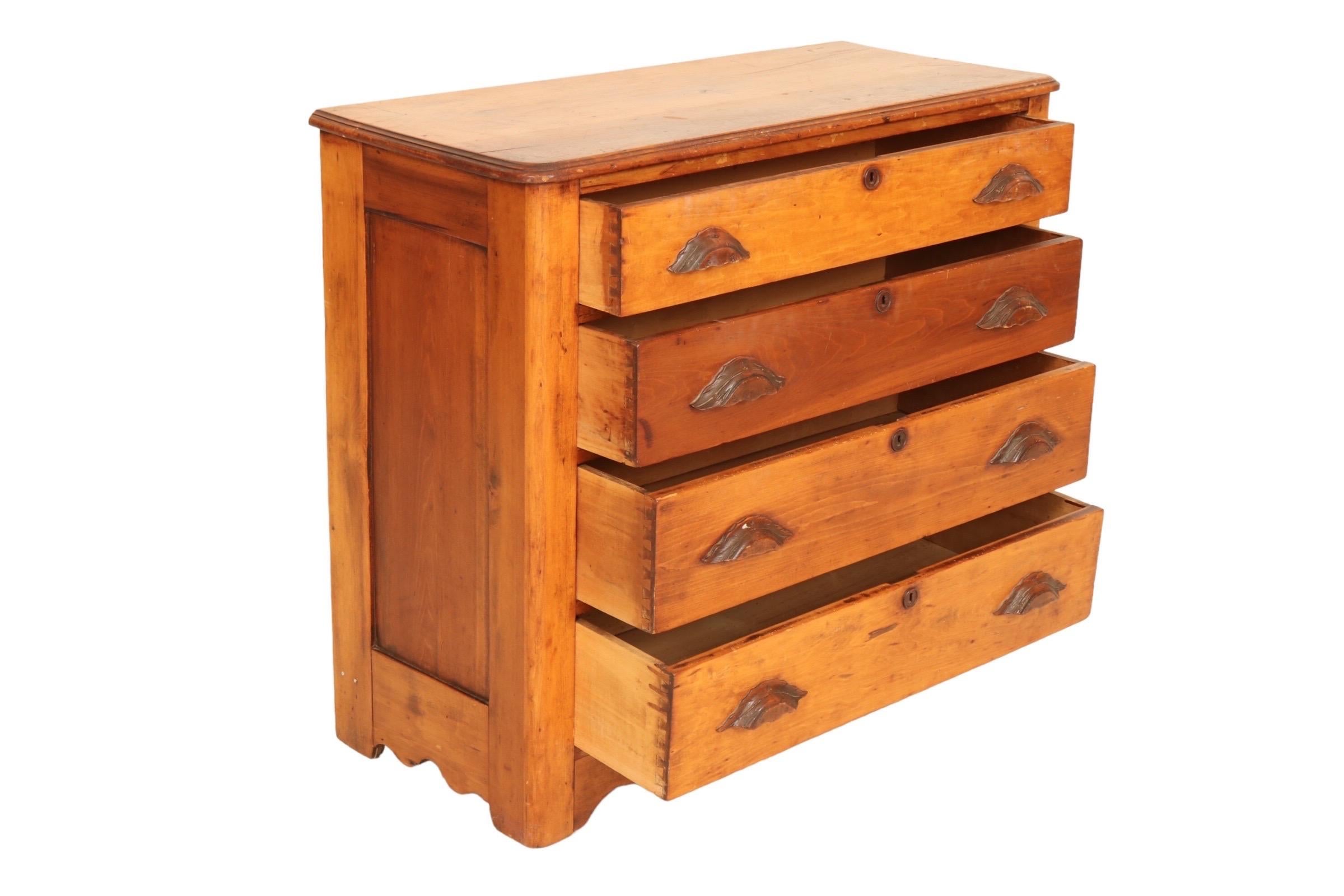 An antique provincial style cherry wood chest of drawers made by cabinet maker Samuel Harper (1818-1904) of Cooperstown, Otsego County, New York. Four hand dovetailed drawers open with decorative carved wood half-moon pull handles. The serpentine