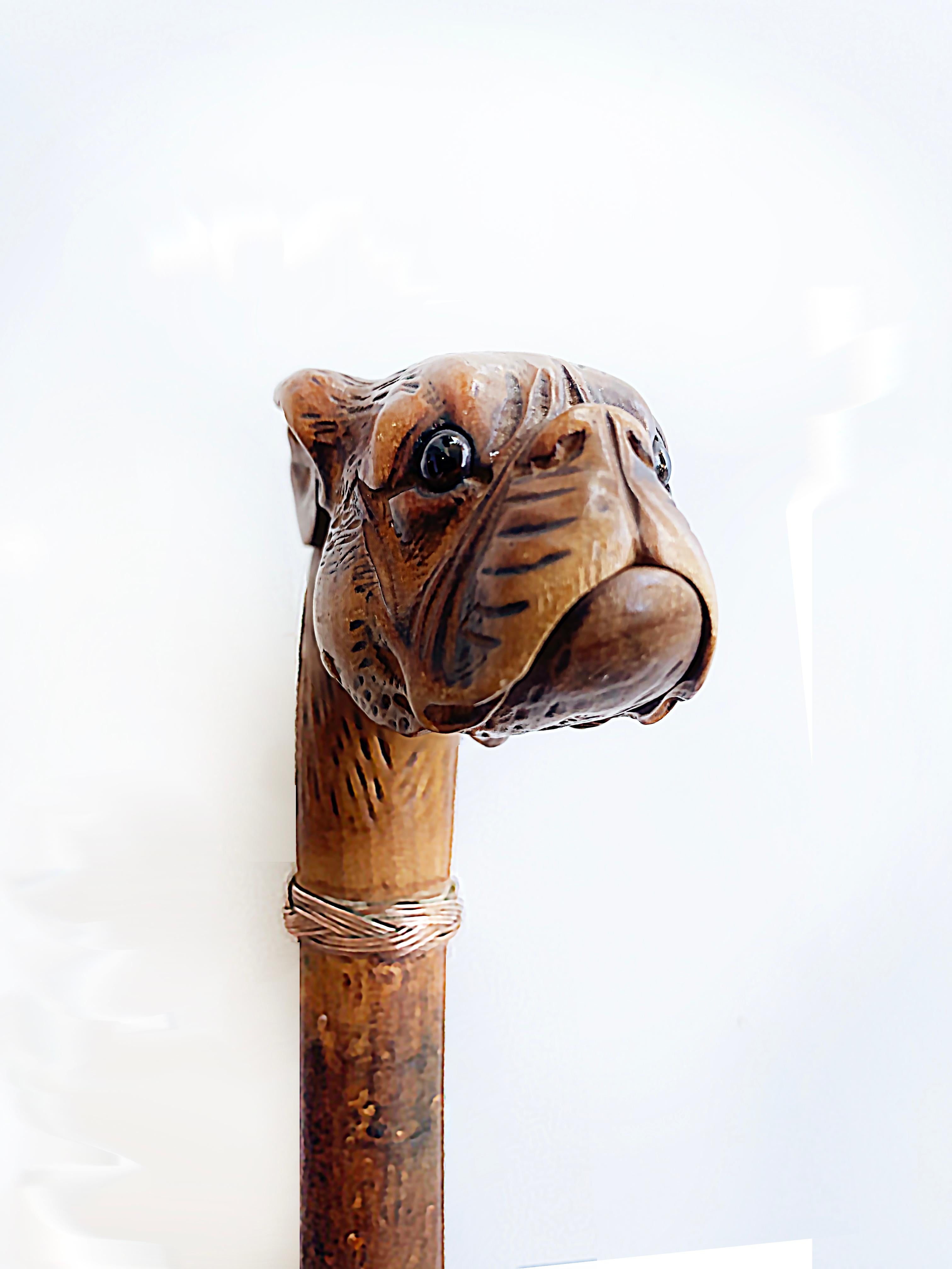 Antique Pug French bull-dog glove holder walking stick cane

Offered for sale is an Antique 19th-century carved hardwood glove holder walking stick. The hand-carved French Bulldog head or a pug dog walking stick has glass eyes. This cane has a