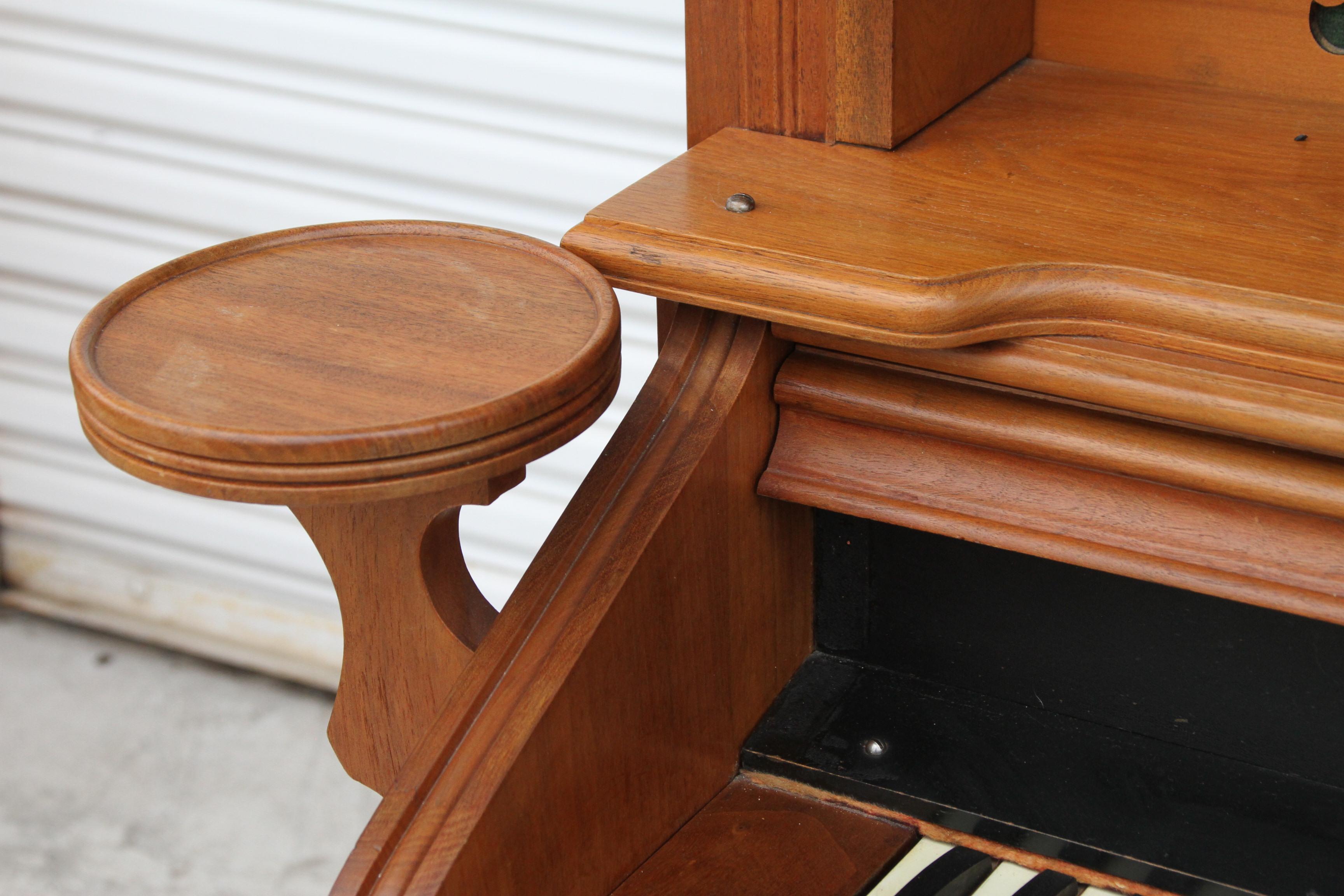 19th Century Eastlake Style Walnut Pump Organ by Chicago Organ Company

Gorgeous elaborately carved antique pump organ made by the Chicago
Organ Co. 

Black Walnut. Features lamp holders and mirrored top. 
Storage above the keys. Includes stool.