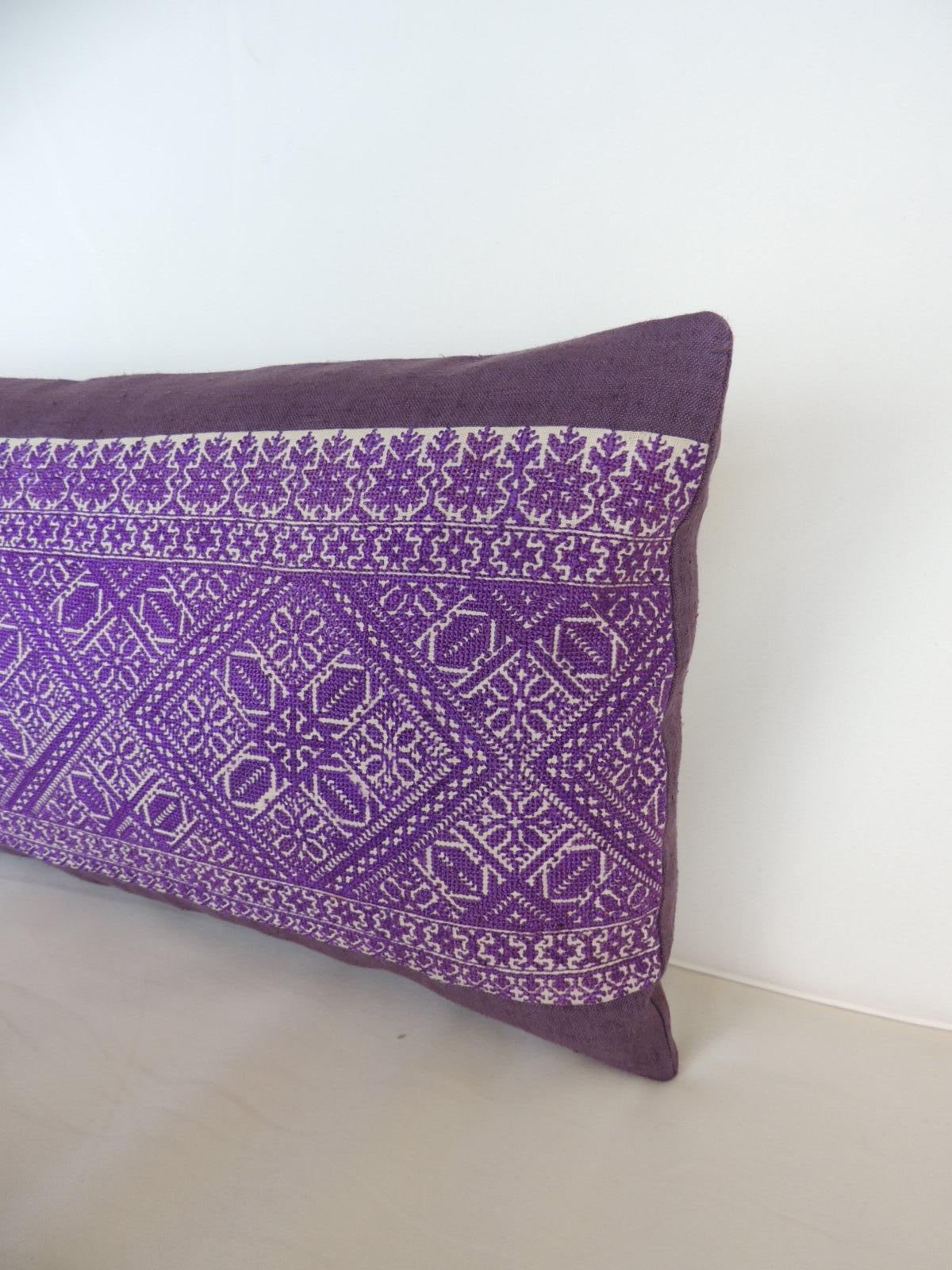 Purple and White Fez Textile Long Decorative Bolster Pillow
Decorative bolster pillow hand-crafted with an artisanal antique textile from the fiber arts traditions of Morocco. The purple Fez embroidery framed in the front center of the bolster