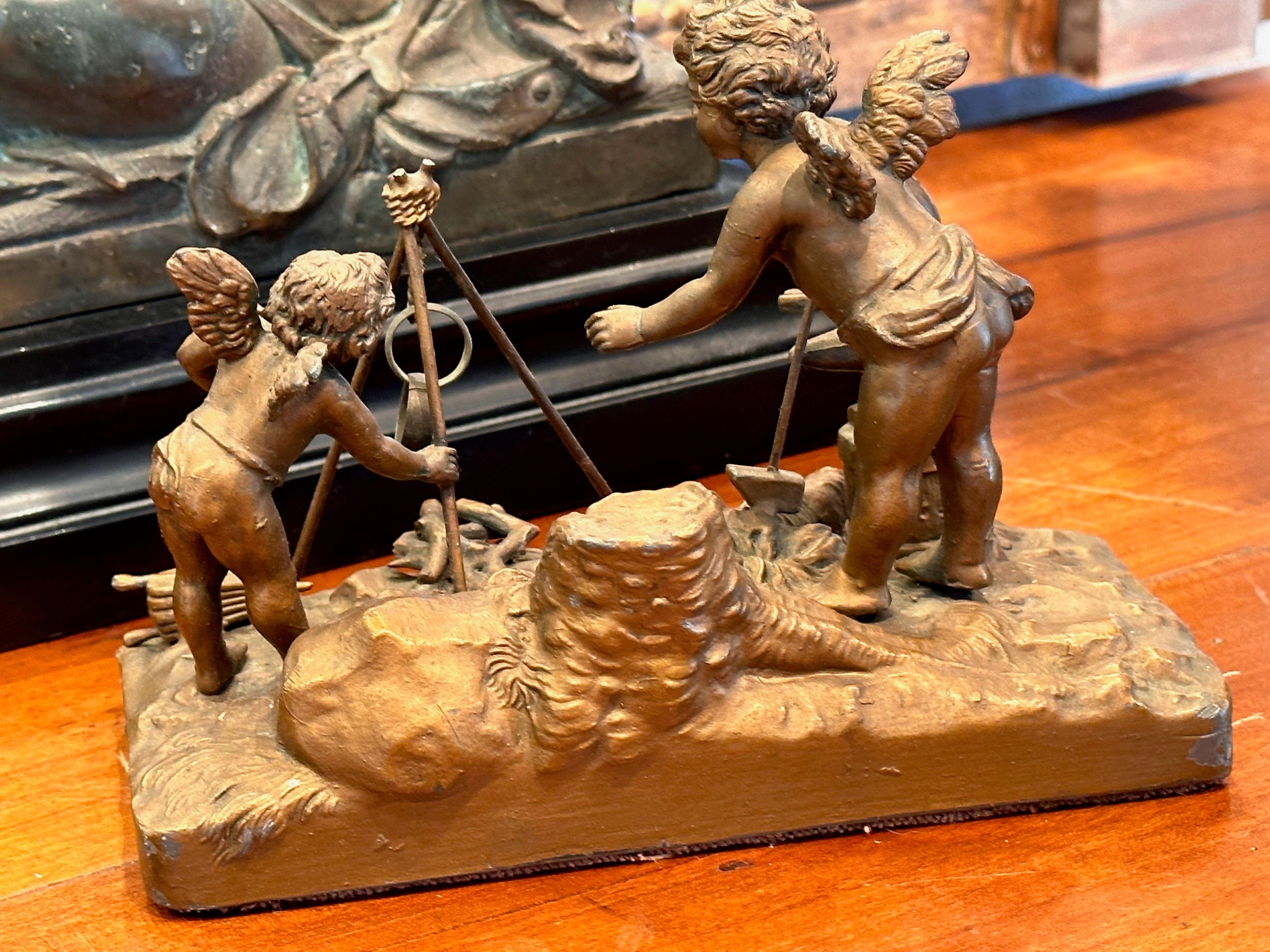 Cherubs around the fire. A bronze patinated sculpture with great detail.a great collector piece.