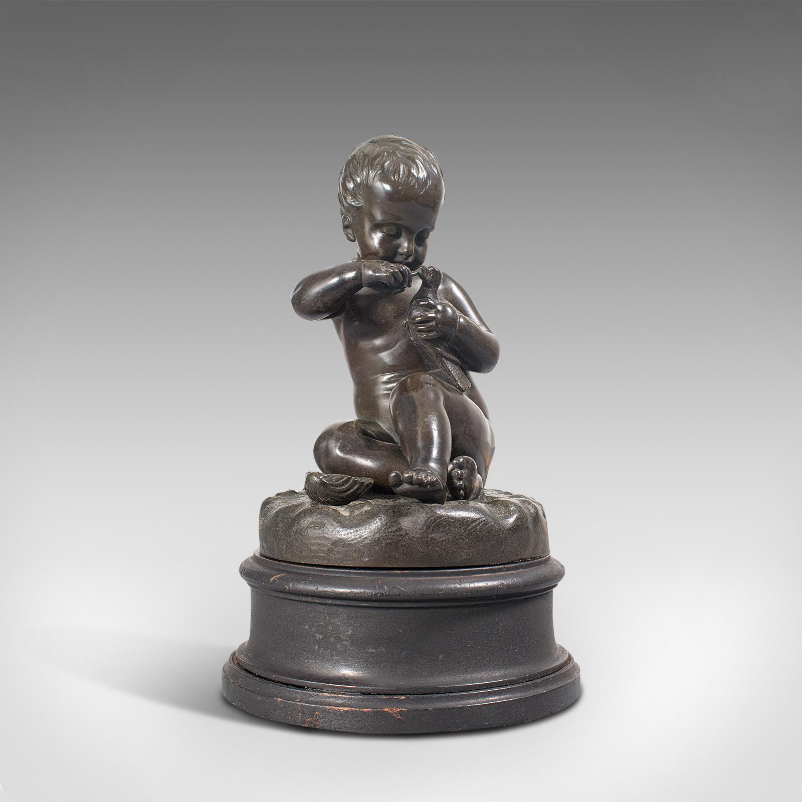 This is an antique putto statue. A French, bronze seated cherub figure with small bird in hand, dating to the late 19th century and later, circa 1900.

Charming putto with fascinating quality
Displaying a desirable aged patina
Inviting bronze