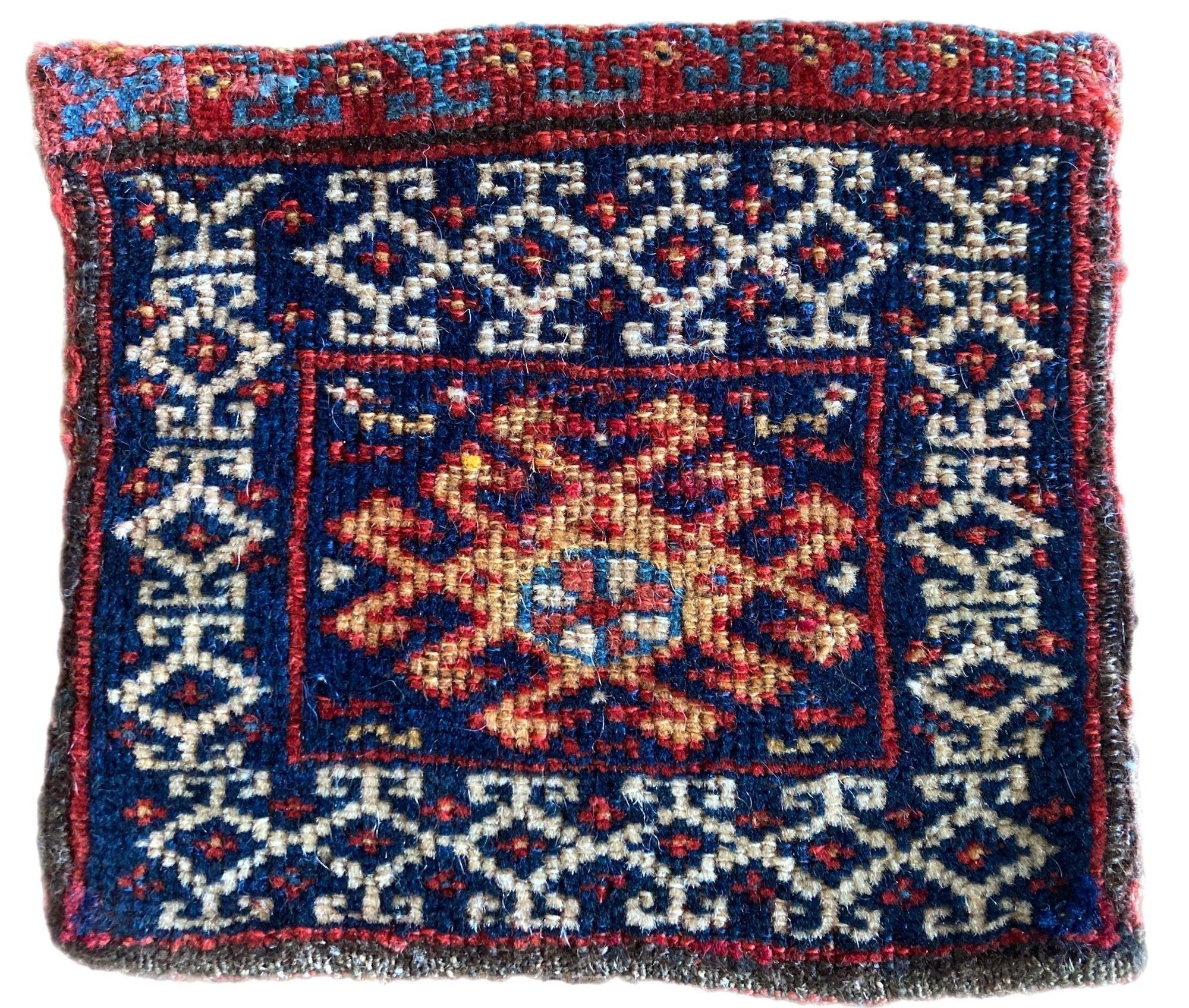 A beautiful antique Chanteh woven by the nomadic Qashqai tribe circa 1880. It is unusually woven on both sides with a red field on one side and a dark indigo on the other. These small vanity bags were woven by the women of the tribe and would have