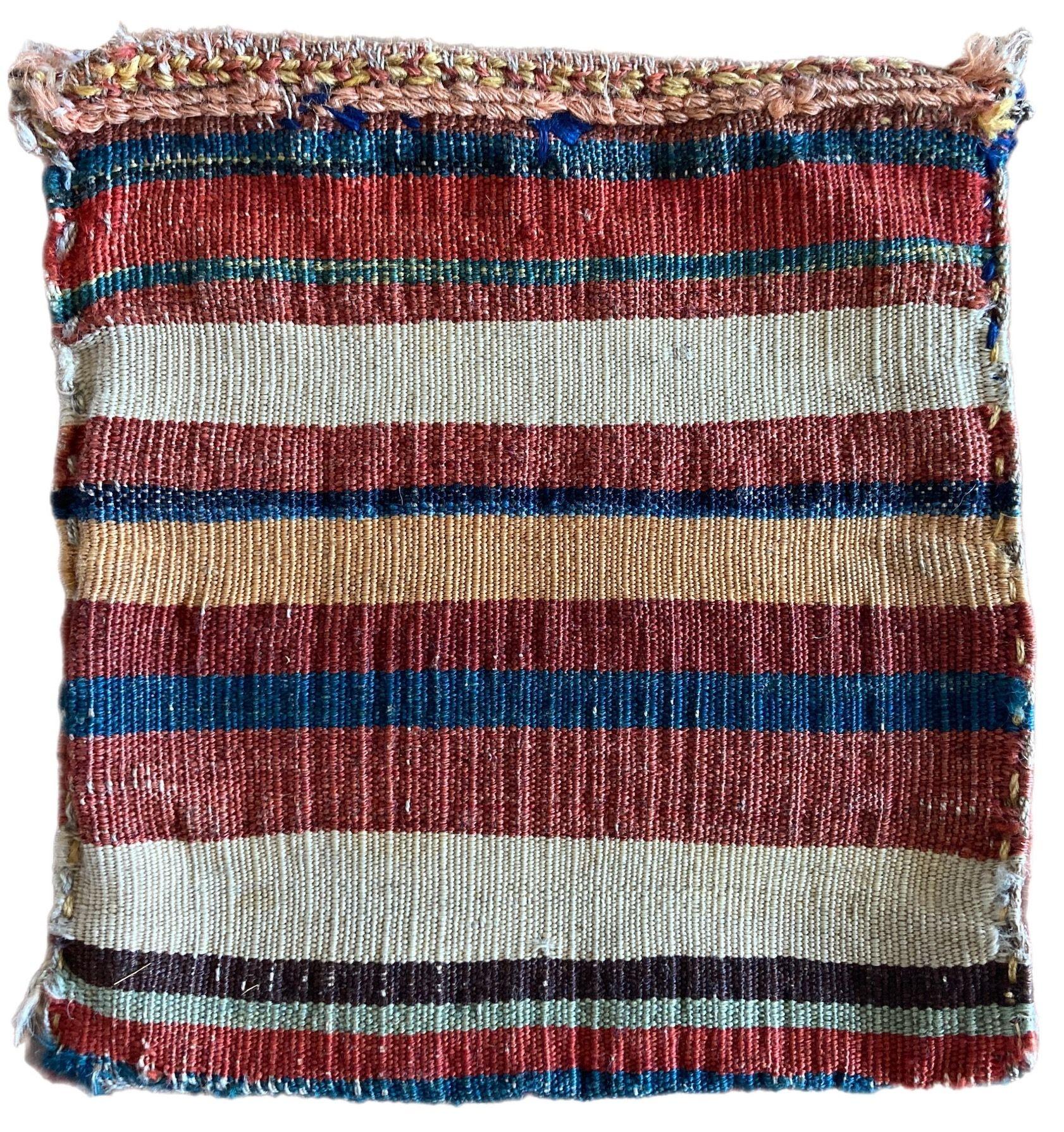 A beautiful antique Chanteh woven by the nomadic Qashqai tribe circa 1880. It is woven on one side with an attractive banded kilim on the reverse. The design features a diamond terracotta medallion on an unusual green field. These small vanity bags
