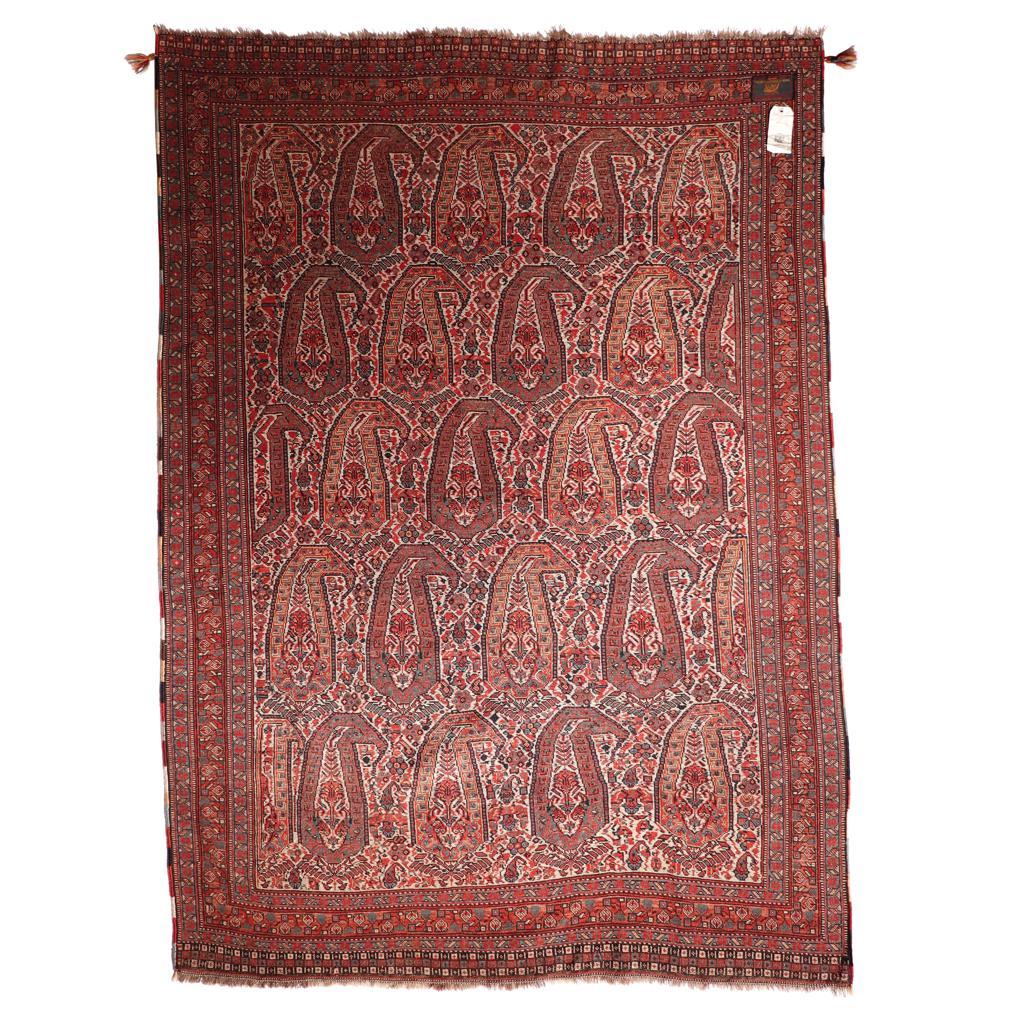 An antique Qashqai rug, Shiraz, Southern Persia. A fine wool pile tightly woven with five interlocking rows of large Boteh designs (curvilinear motif with a curled top, resembling both fruit and leaf) in alternating edge colors on a floral foliate