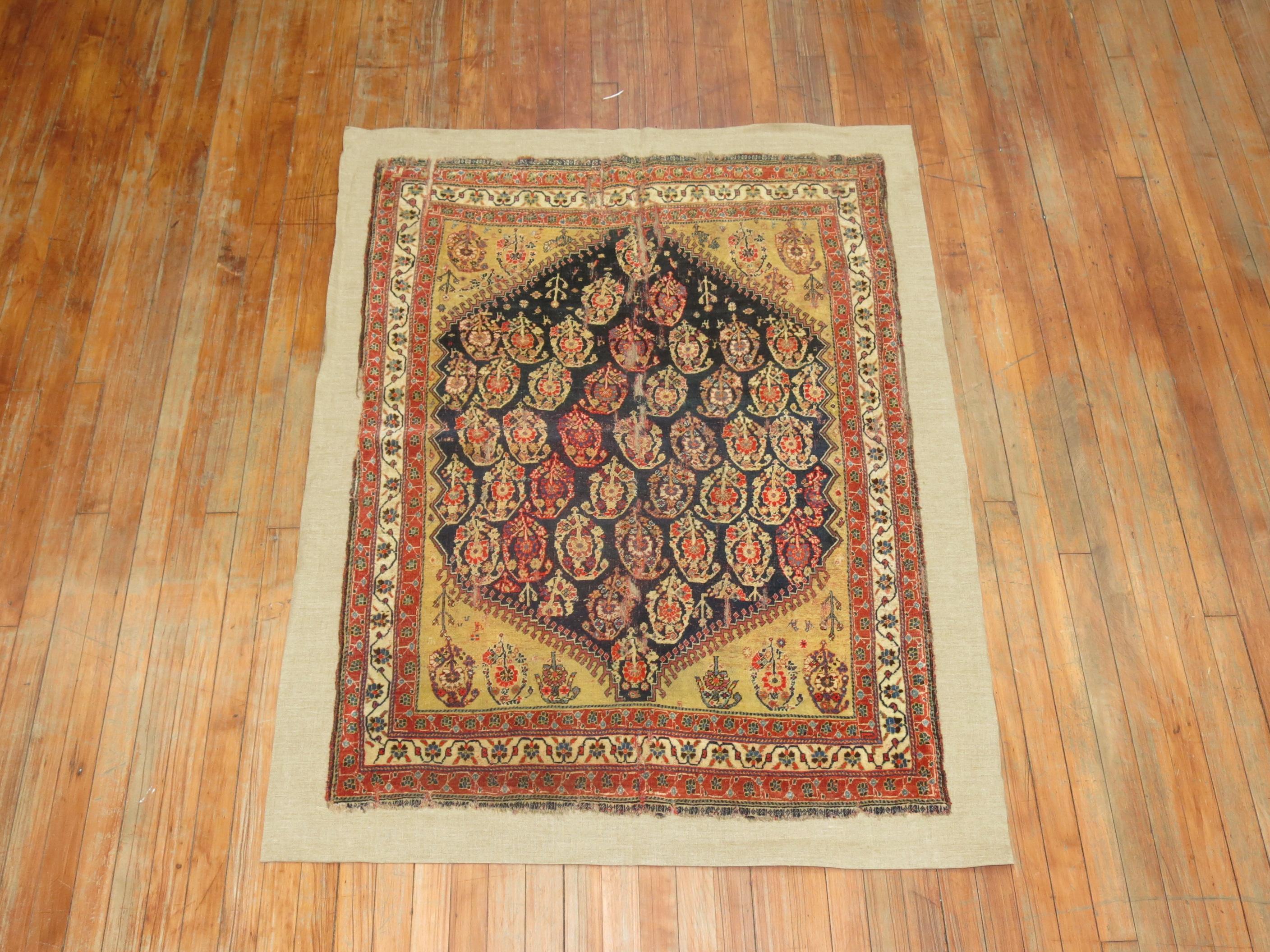 Tribal Antique Qashqai Rug Stitched on Linen For Sale