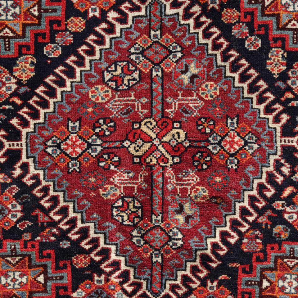 An antique qashqai saddle bag front panel, Shiraz, Southern Persia. A very fine wool pile in Turkish knot tightly woven on an all wool base. A floral design consisting of one hooked outline red medallion in light blue, orange, yellow, white and