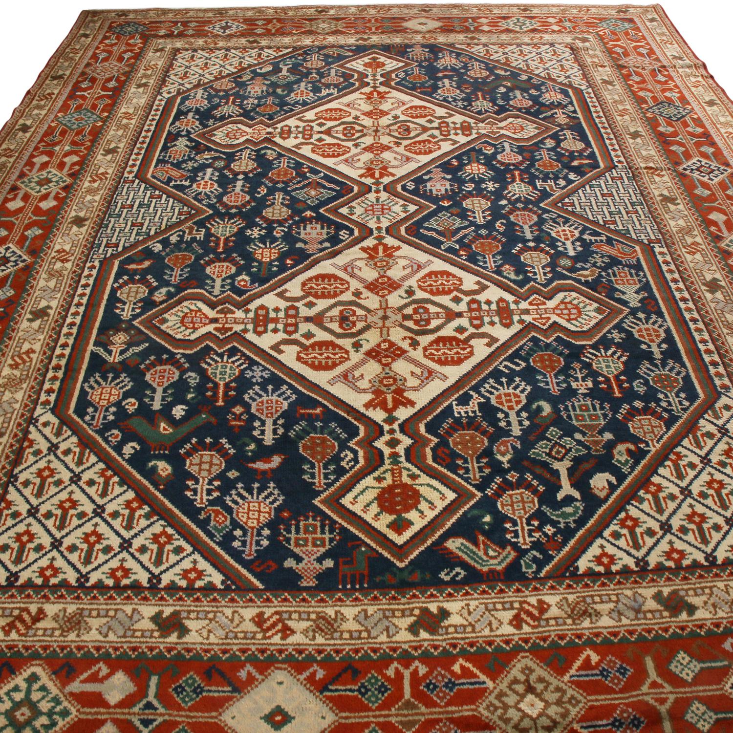 Originating from Ireland between 1890-1900, this antique Qasqhai wool rug presents an intriguing array of russet, navy blue, and beige colourways emphasizing the tasteful dimensionality of its medallion field design, a level of detail seldom seen