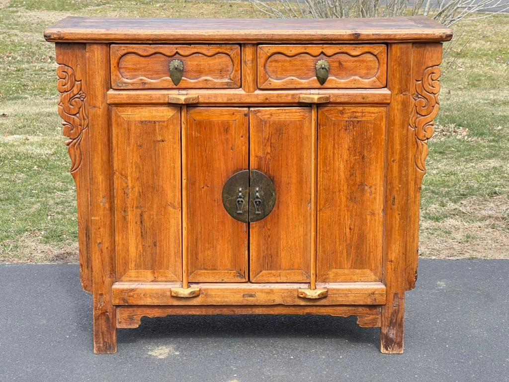 Introducing an Antique Qing Dynasty Butterfly Cabinet from the 1800s, a rare and exquisite piece that embodies the elegance and craftsmanship of the Qing Dynasty. Handcrafted from fine hardwood, this cabinet features a butterfly motif in its form,