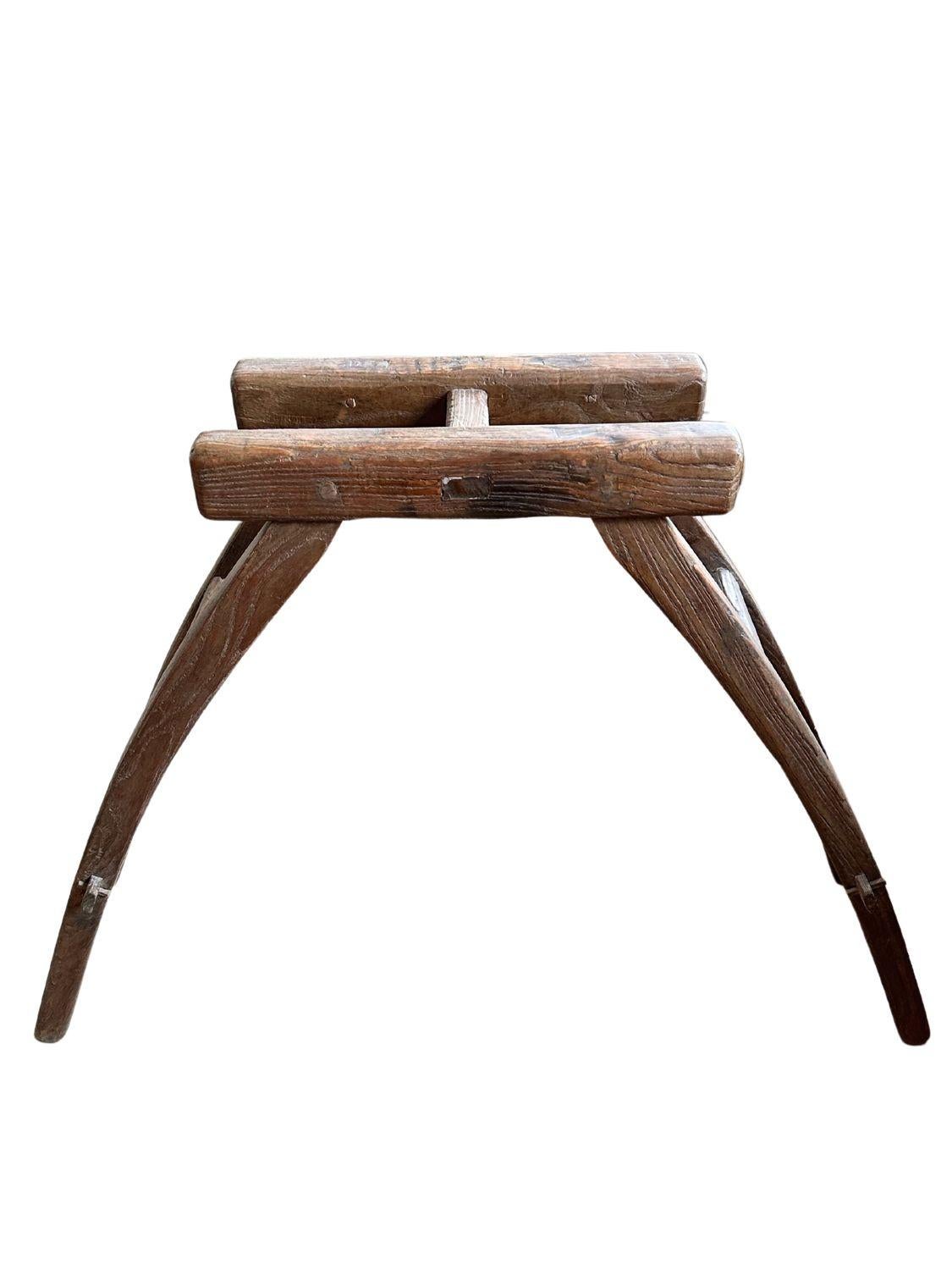 This exquisite antique horse mounting step, hailing from the Shaanxi region, dates back to the early 19th century during the Qing Dynasty. Crafted from aged elm wood, it showcases a rich, rustic patina that highlights its historical significance and