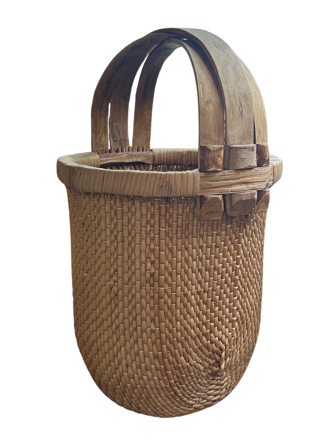 This antique Qing Dynasty rattan basket, dating back to circa 1910, is a beautiful example of traditional craftsmanship. The basket features an intricate weave pattern that highlights the artisan's skill, while the durable rattan material adds a