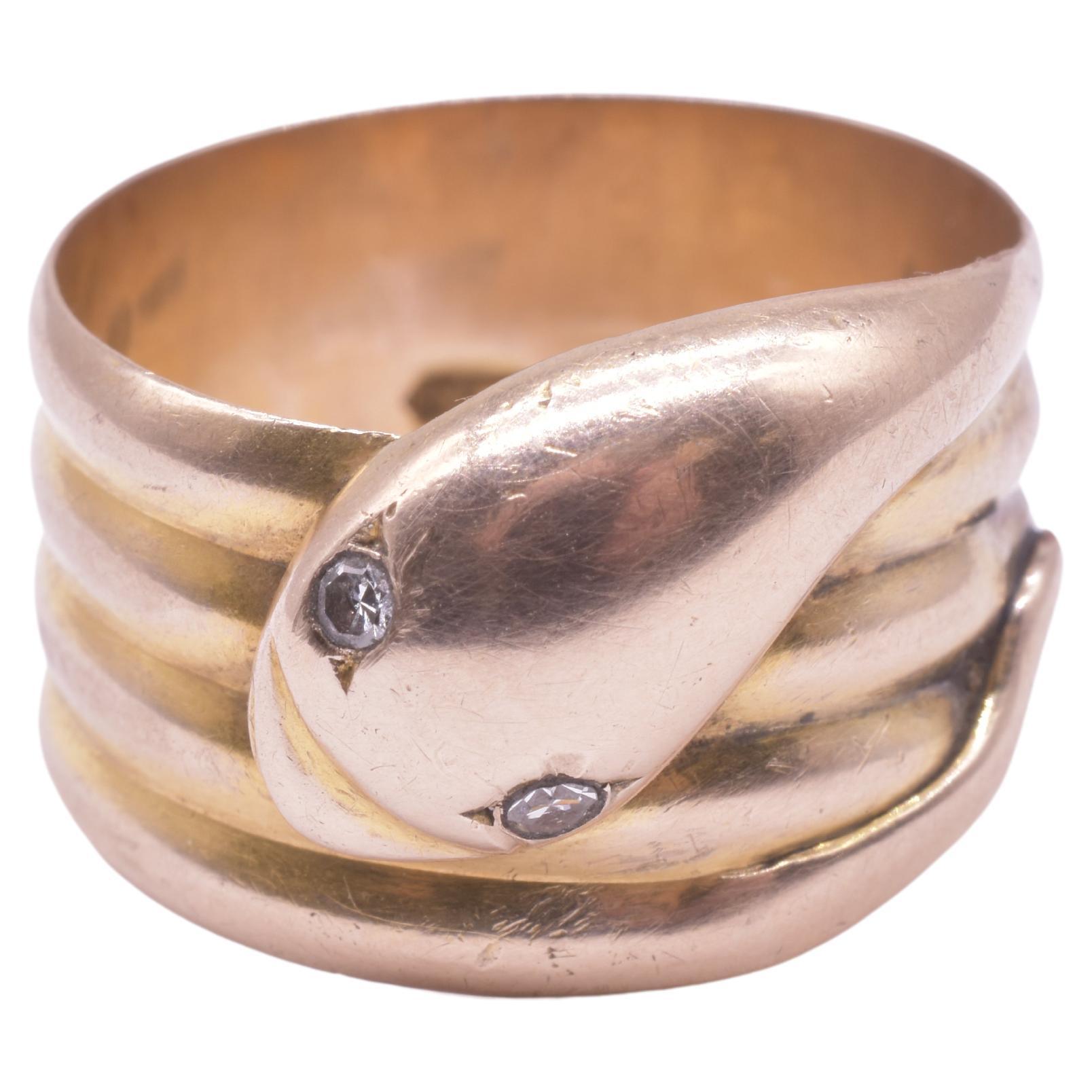 9K antique snake ring with the snake wrapped four times around and revealing a very cute snake expression and cute round diamond eyes encased in a carved setting. The ring is hallmarked Birmingham 1910. The snake with its tail in its mouth, an