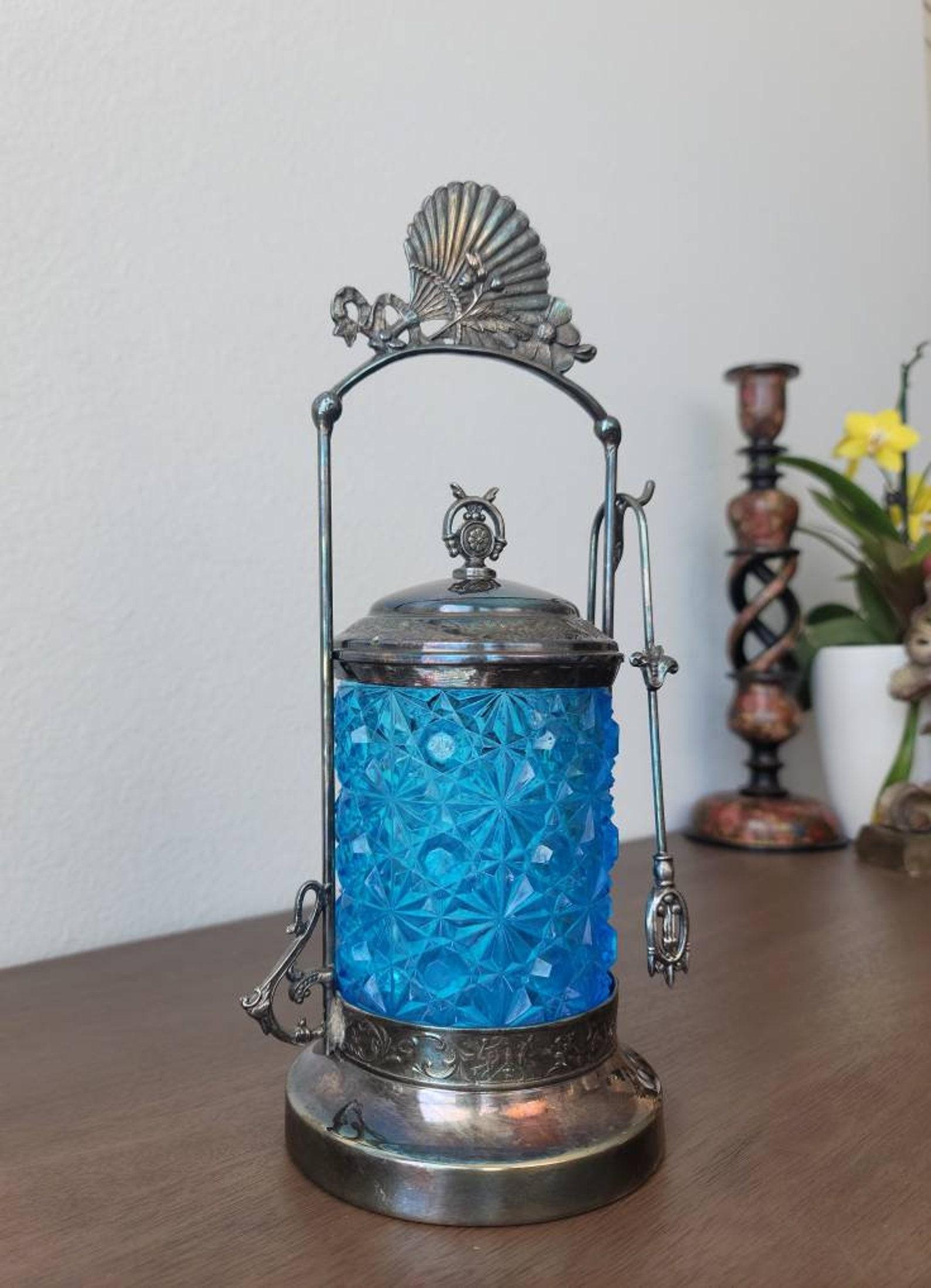 A sophisticated antique American Victorian late 19th century Columbia Silver Company signed quadruple-plate pickle castor service set with daisy and button pattern cut crystal electric blue glass jar, ornate silver-plated decorative stand, lid and