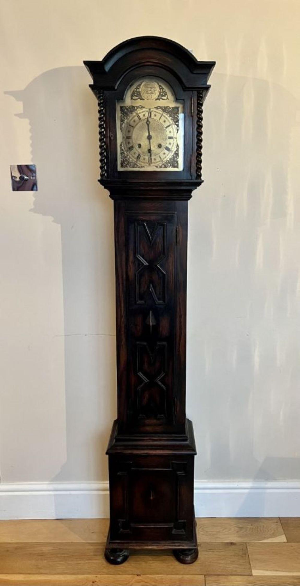 Antique quality brass arched dial grandmother clock having a quality brass arched dial with a silvered chapter ring with Roman numerals, original hands, eight day chiming movement, barley twist supports to the glass door, quality oak moulding to the